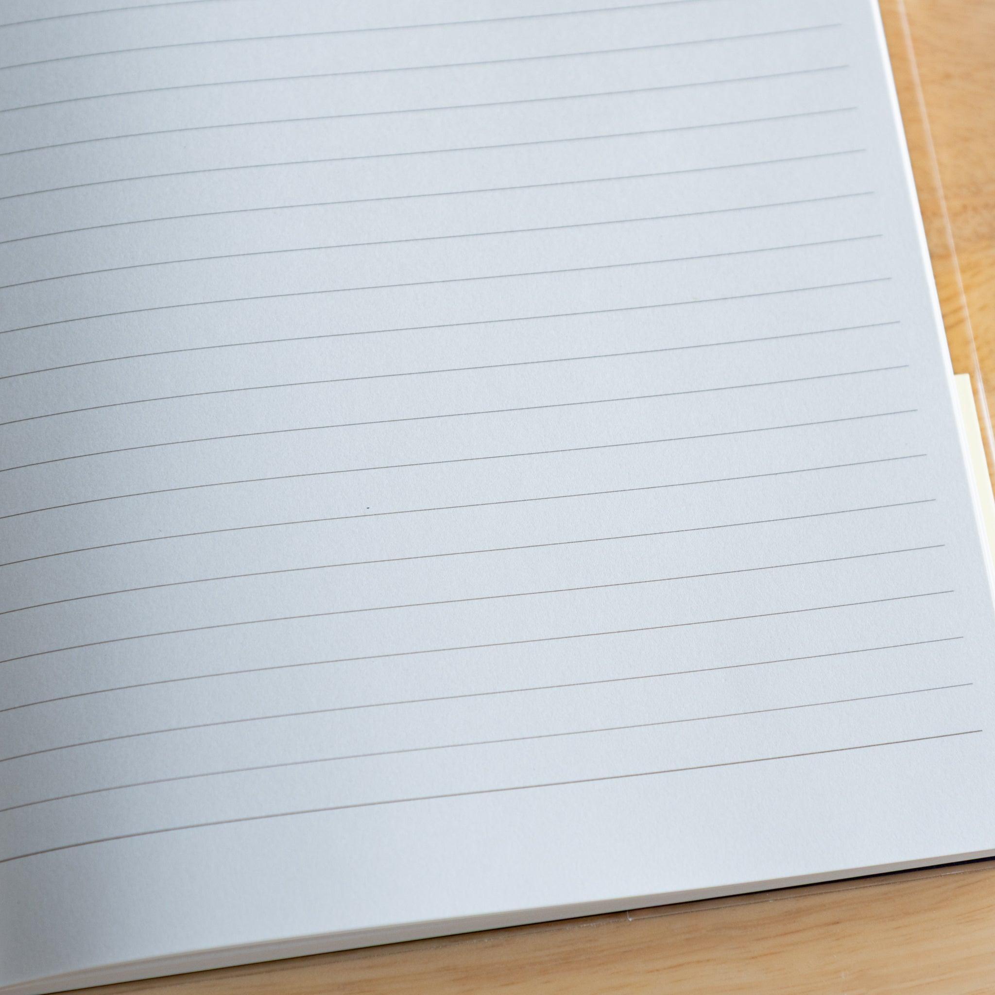 Close-up of lined white page in a Premium CD Japanese notebook, featuring smooth texture for fountain pen writing.