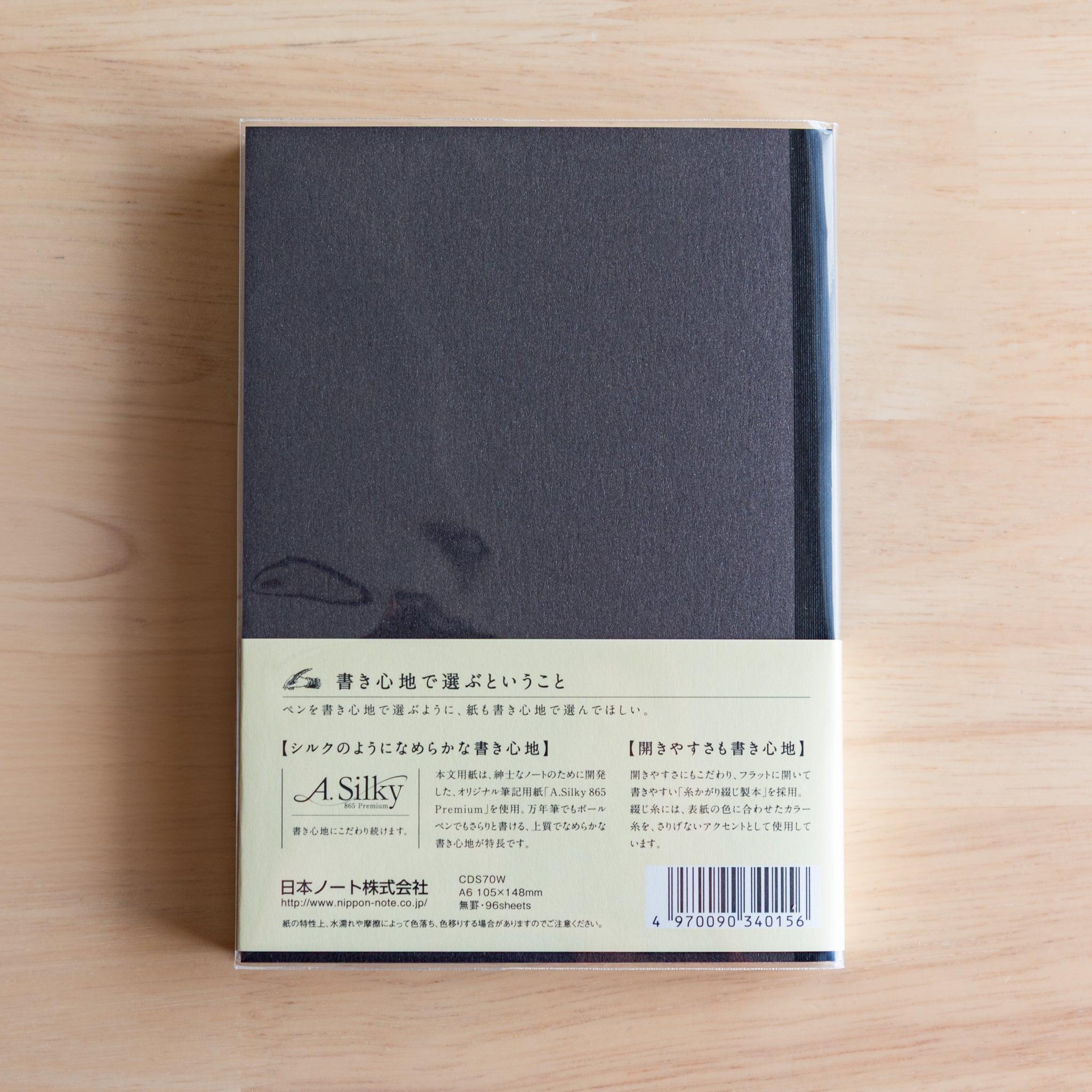 Back of black Premium C.D. Japanese notebook with cream label explaining A.Silky 865 Premium paper.