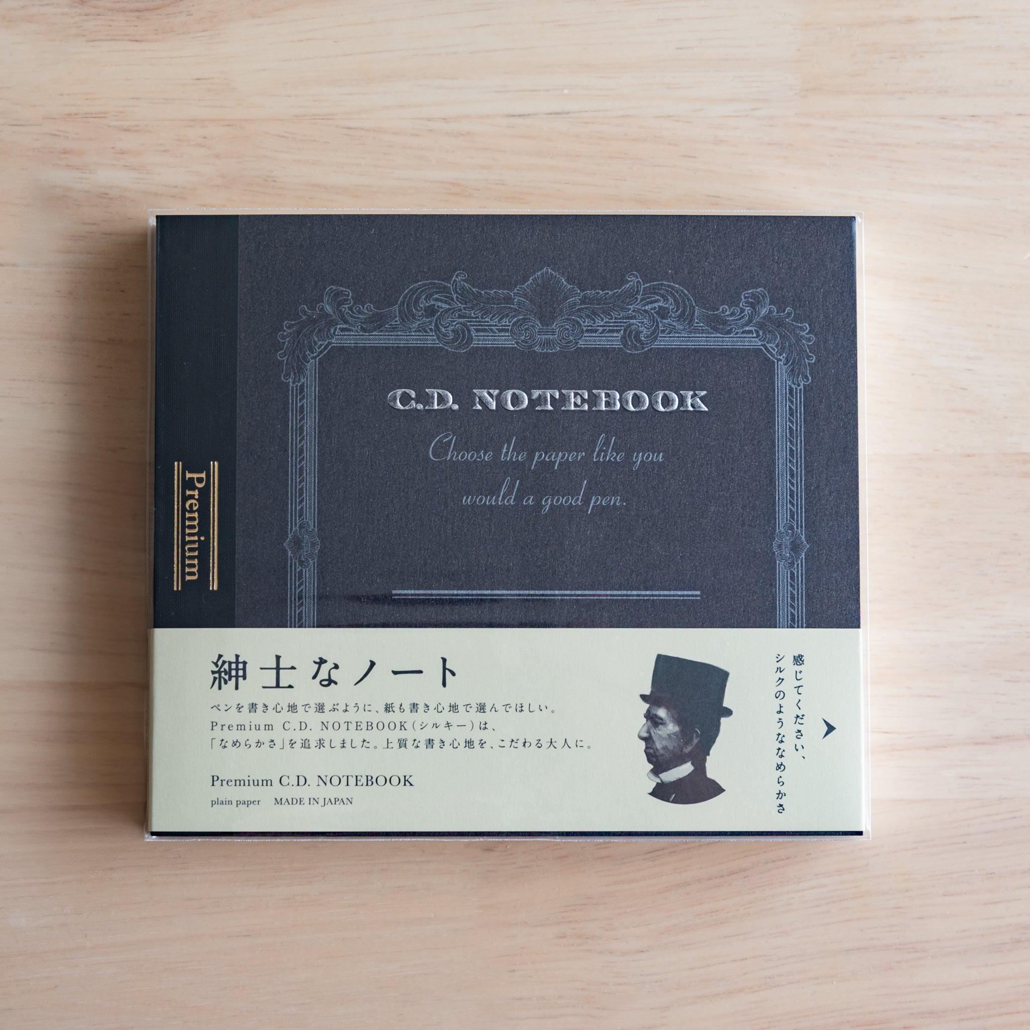 Black Wide Premium CD Japanese notebook with cream band and fountain pen, highlighting its elegant paper for pen lovers.