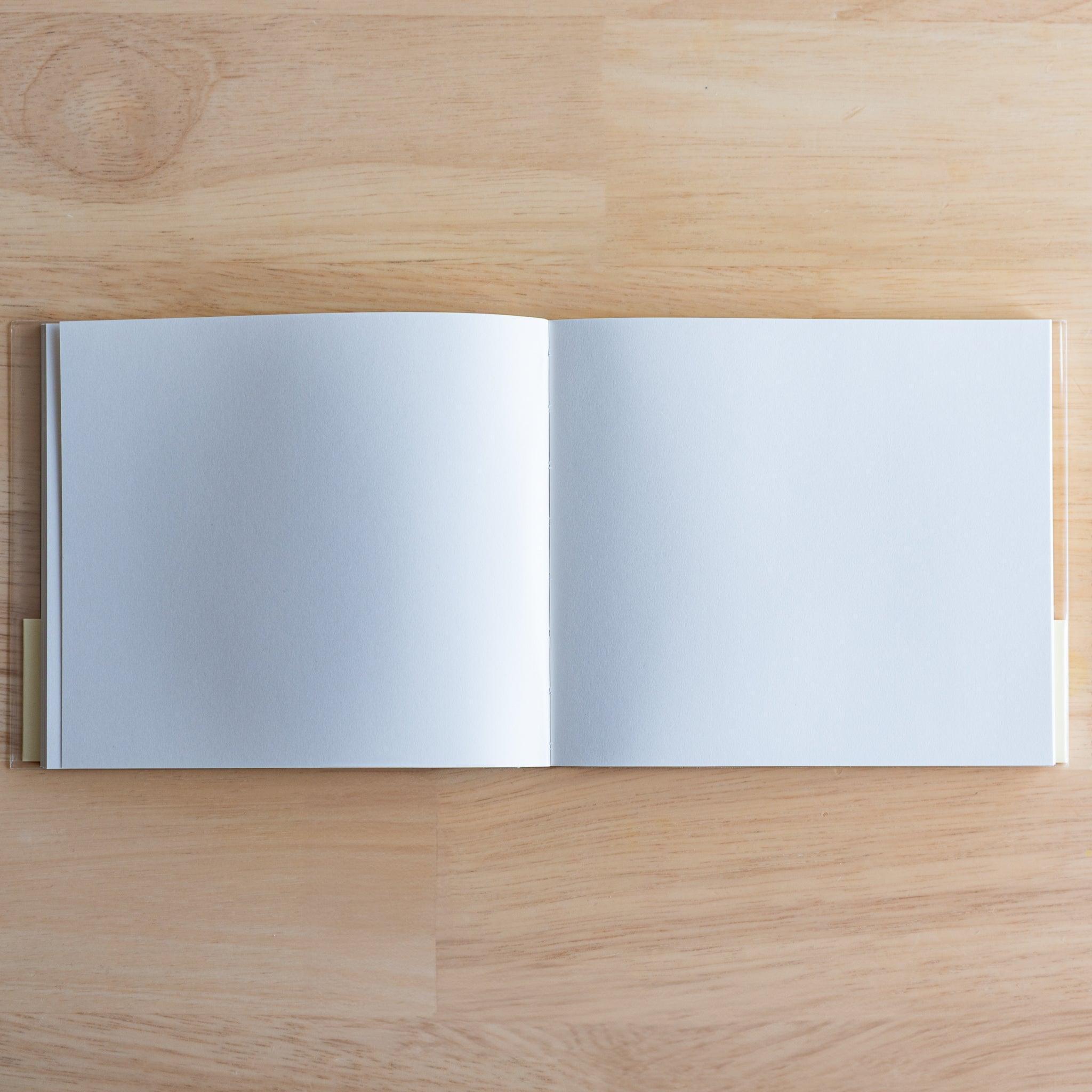 Open Premium C.D. Japanese notebook showing two plain white pages, made for smooth writing with fountain pens.