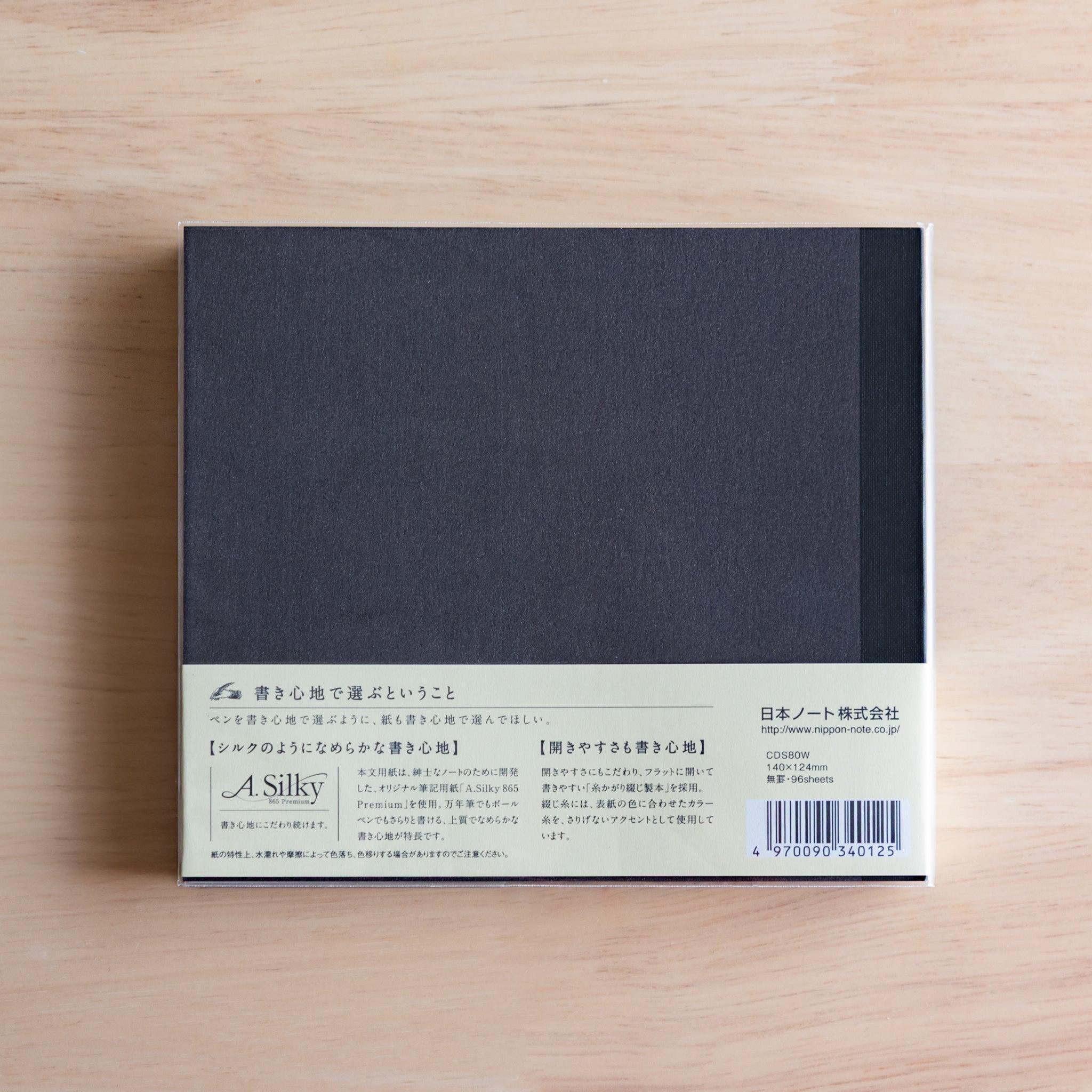Back of black Premium C.D. Japanese notebook with cream label explaining A.Silky 865 Premium paper.