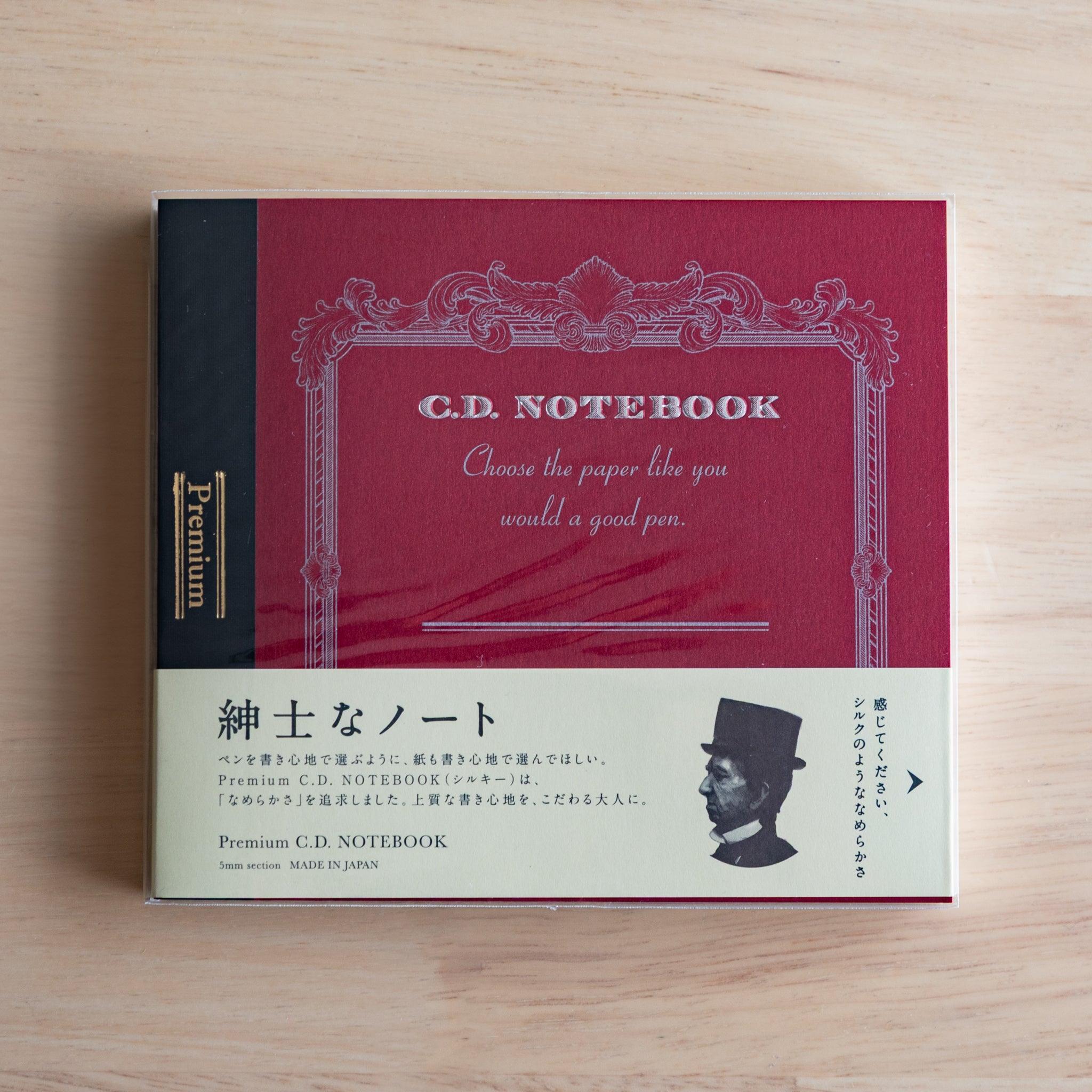 Red Wide Premium CD Japanese notebook with cream band and fountain pen, highlighting its elegant paper for pen lovers.