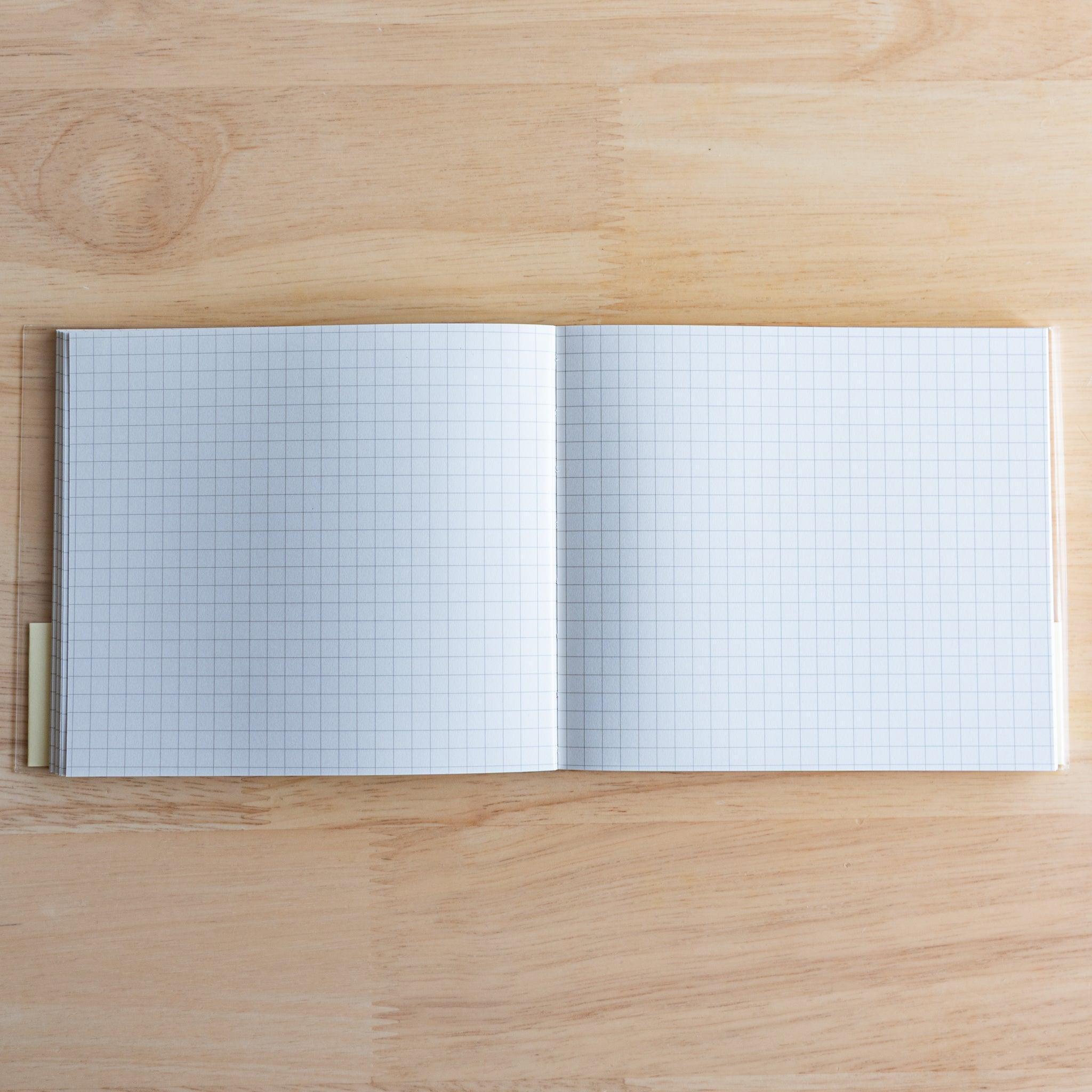 Open Premium C.D. Japanese notebook showing two grid white pages, made for smooth writing with fountain pens.