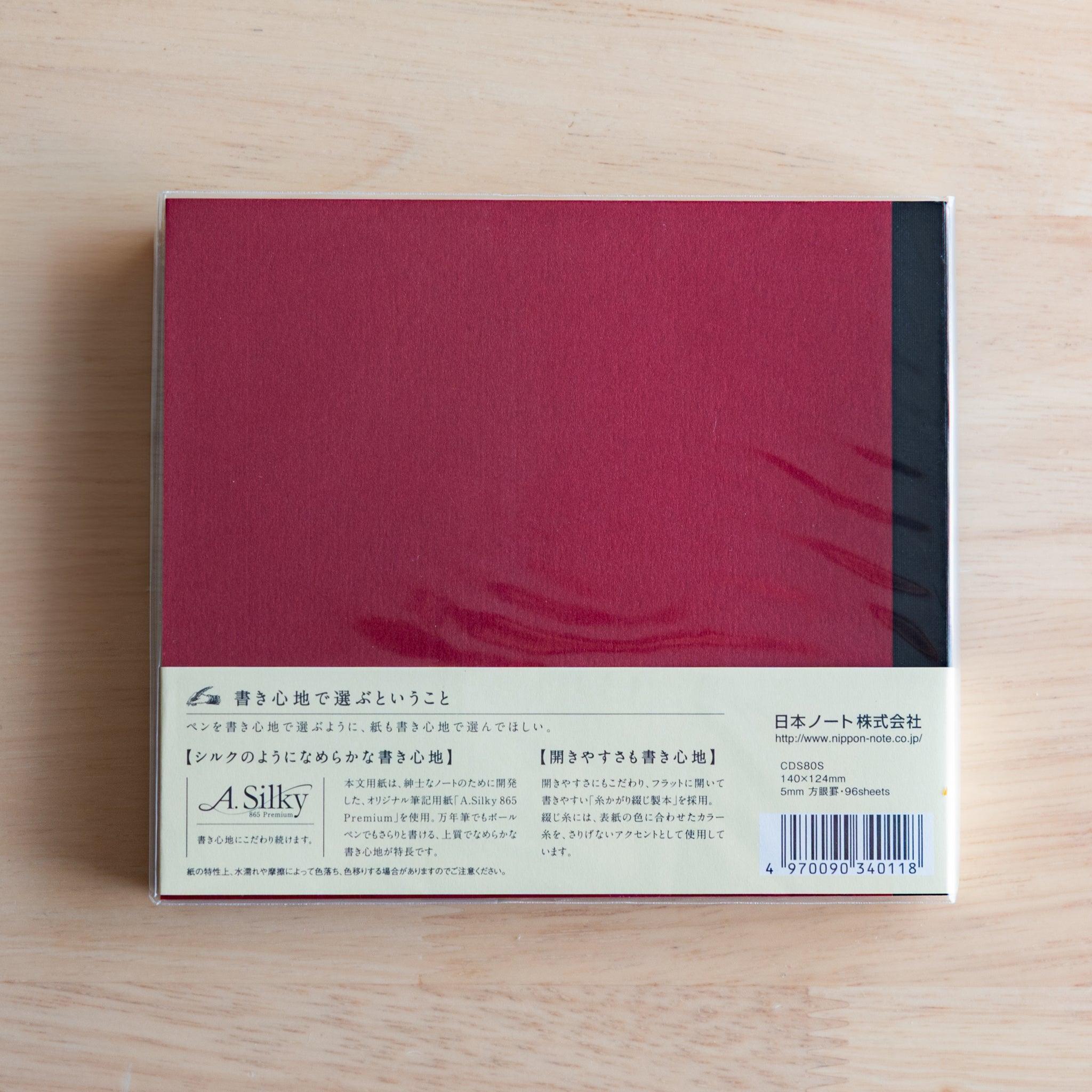 Back of red Premium C.D. Japanese notebook with cream label explaining A.Silky 865 Premium paper.