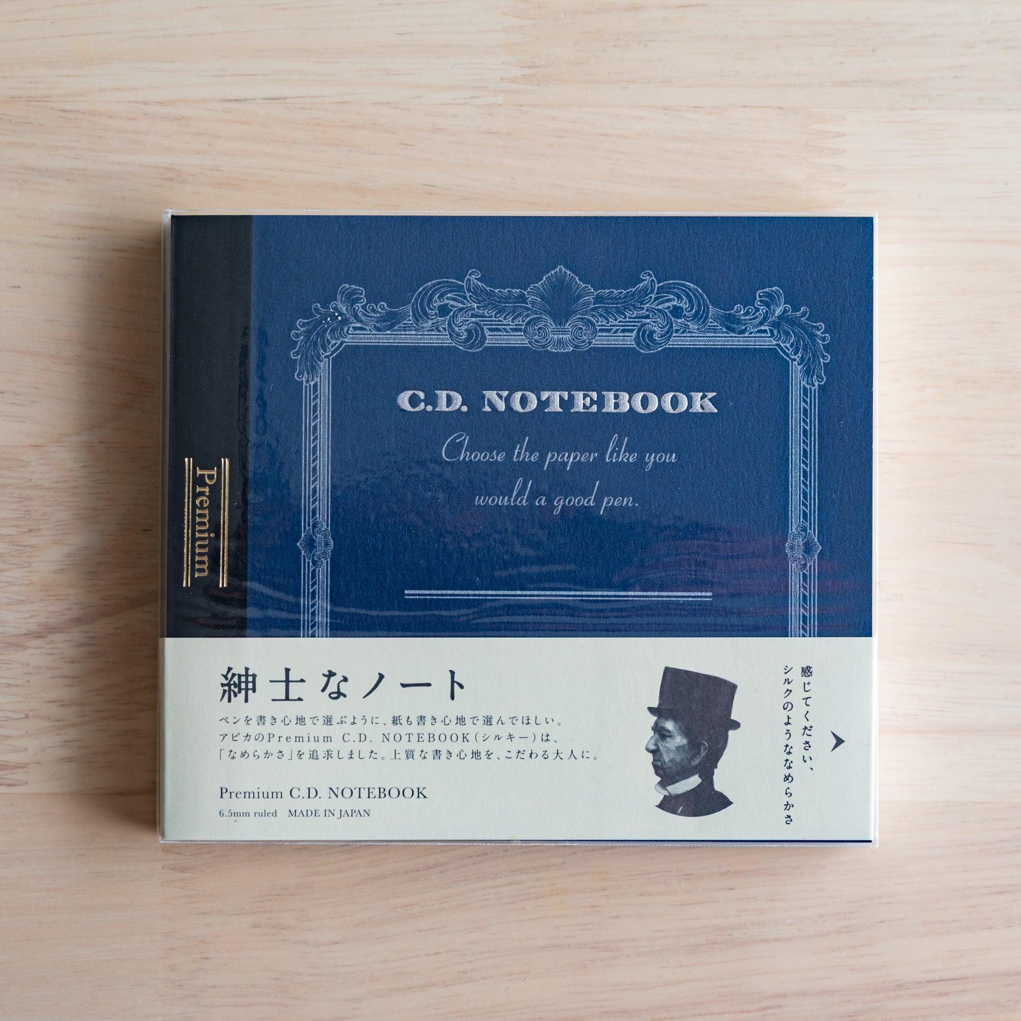 Blue Wide Premium CD Japanese notebook with cream band and fountain pen, highlighting its elegant paper for pen lovers.