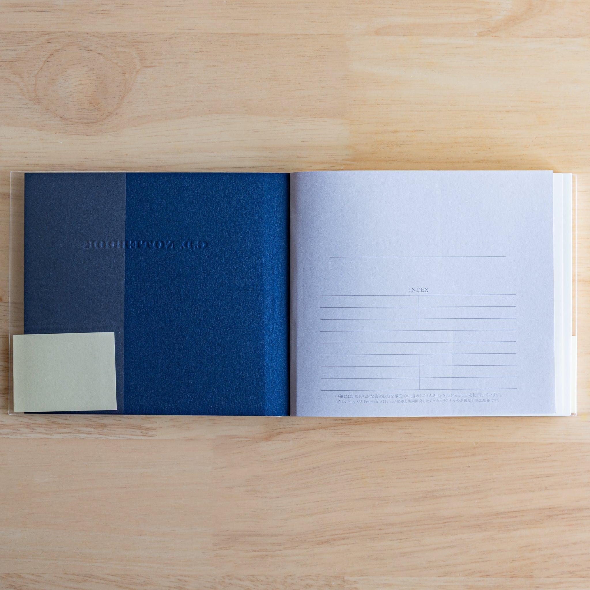 Inside view of a blue Premium CD Japanese notebook showing textured inner cover and index page.