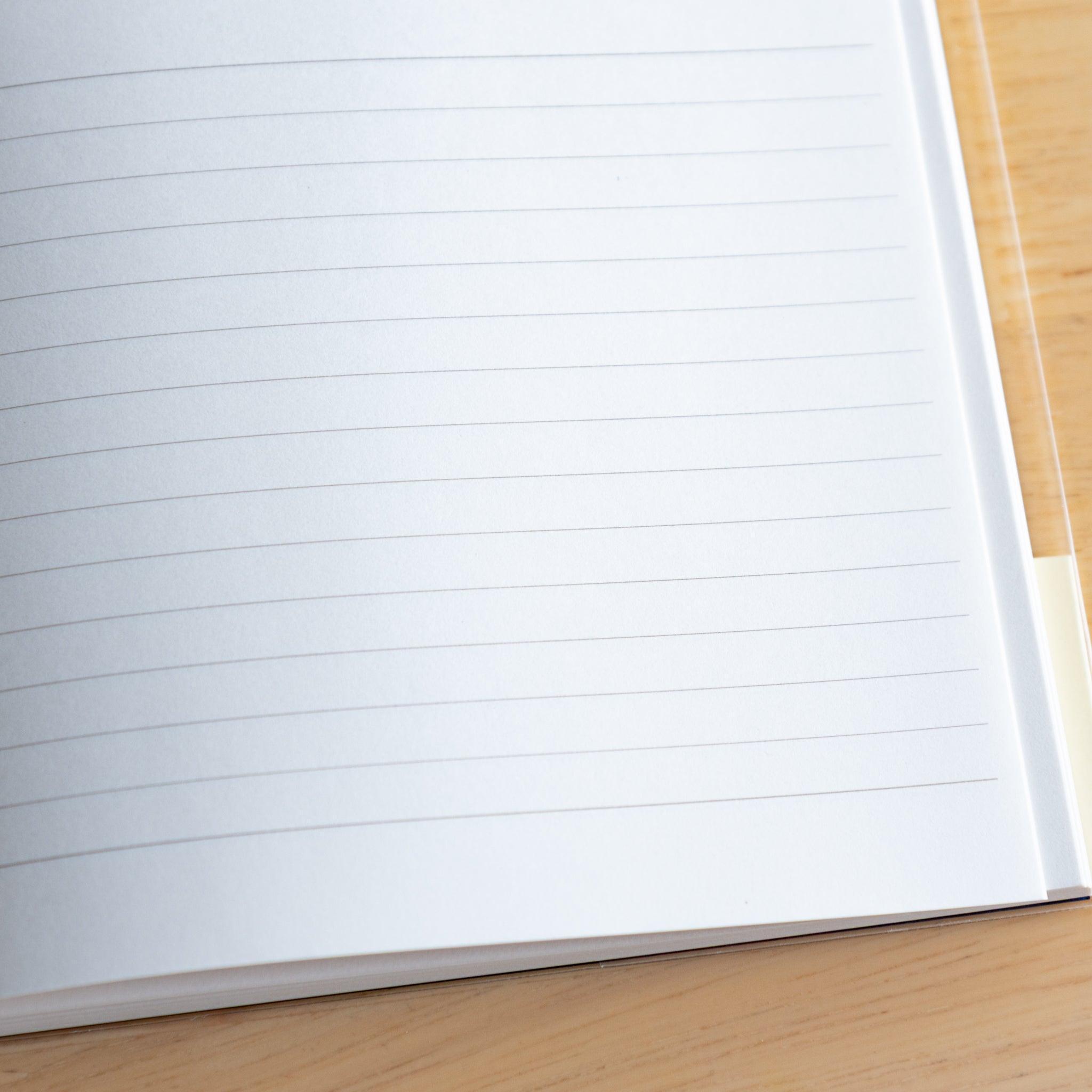 Close-up of lined white page in a Premium CD Japanese notebook, featuring smooth texture for fountain pen writing.
