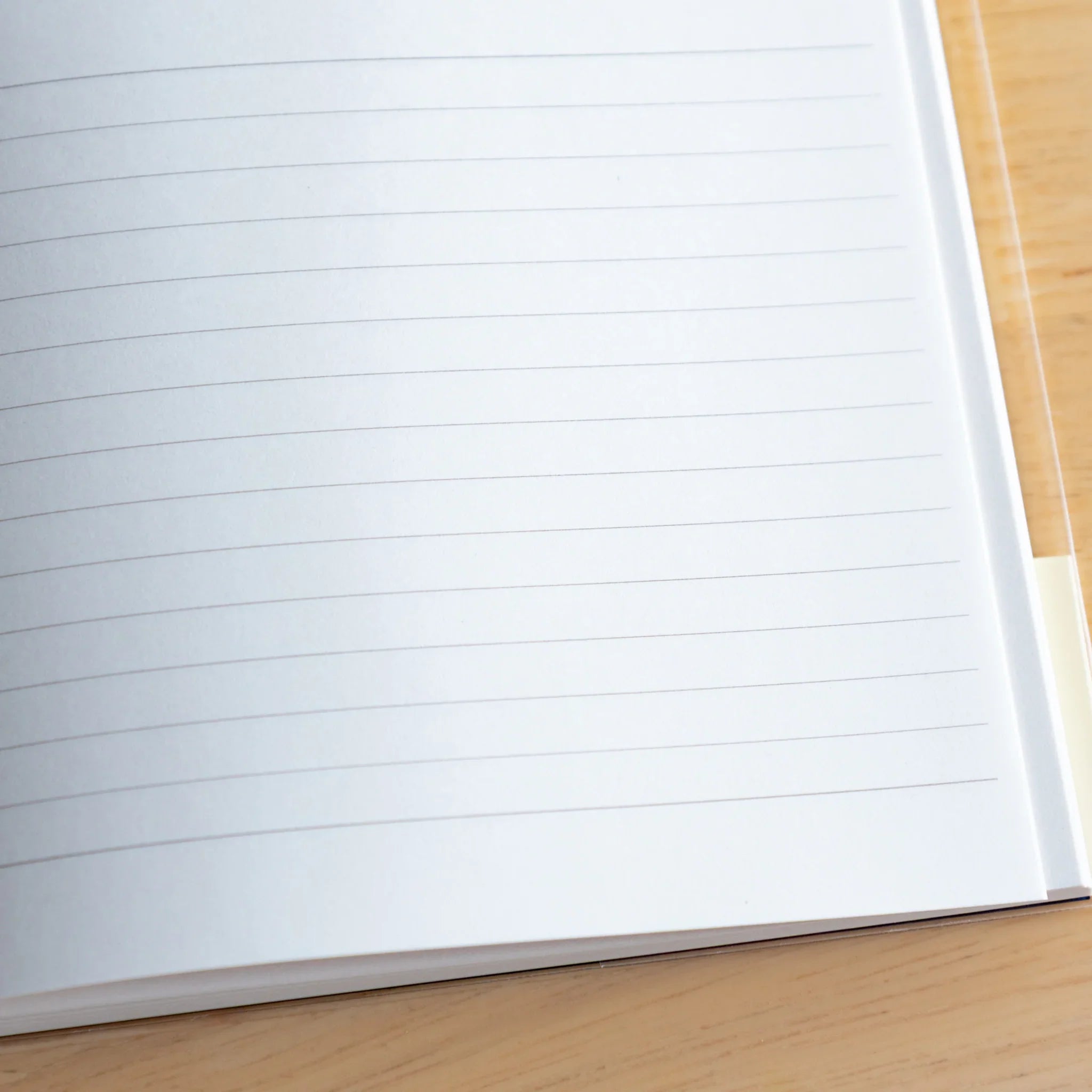 Apica Premium CD Fountain Pen Notebook Silky closed flat navy cover on wooden table surface Japanese premium