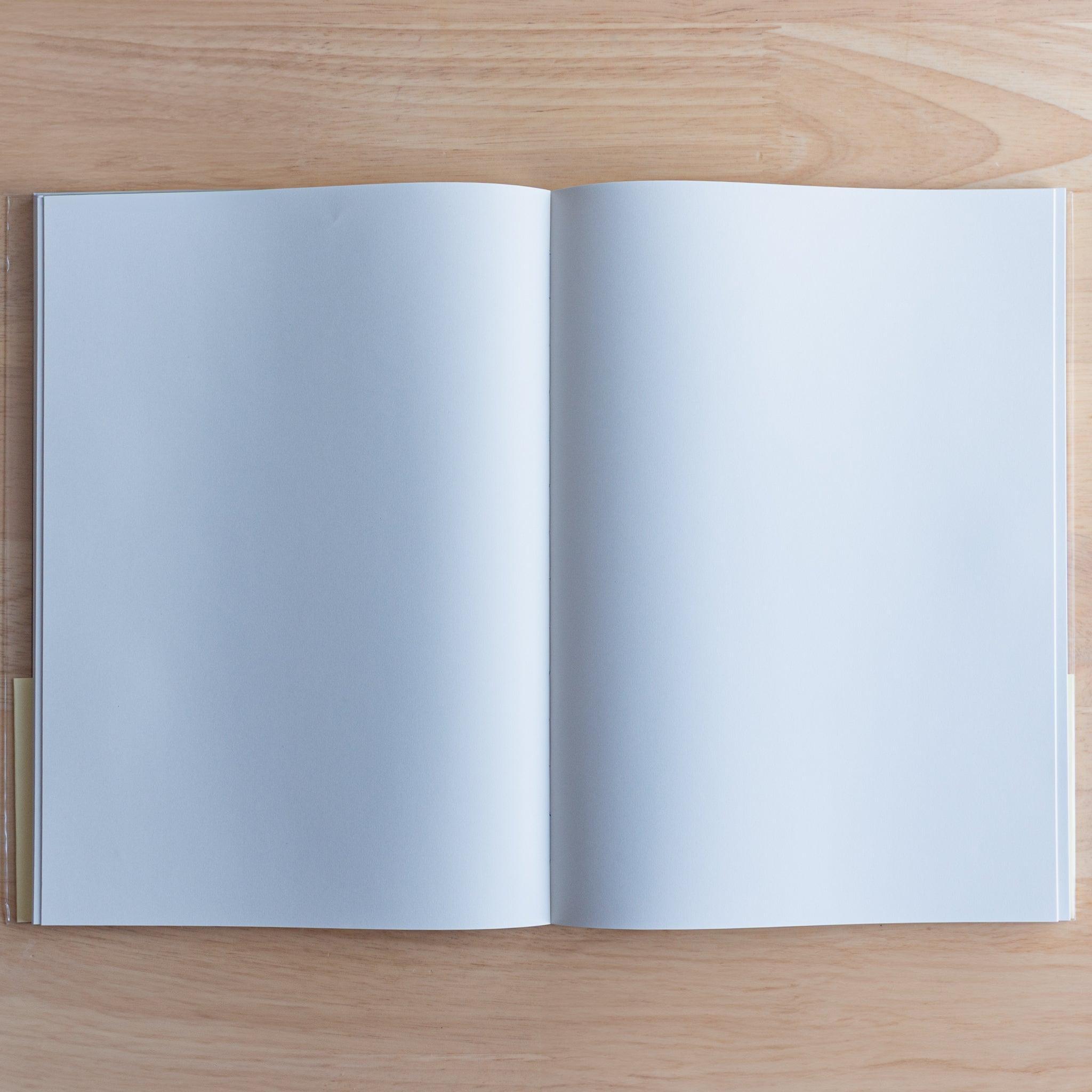 Open Premium C.D. Japanese notebook showing two plain white pages, made for smooth writing with fountain pens.