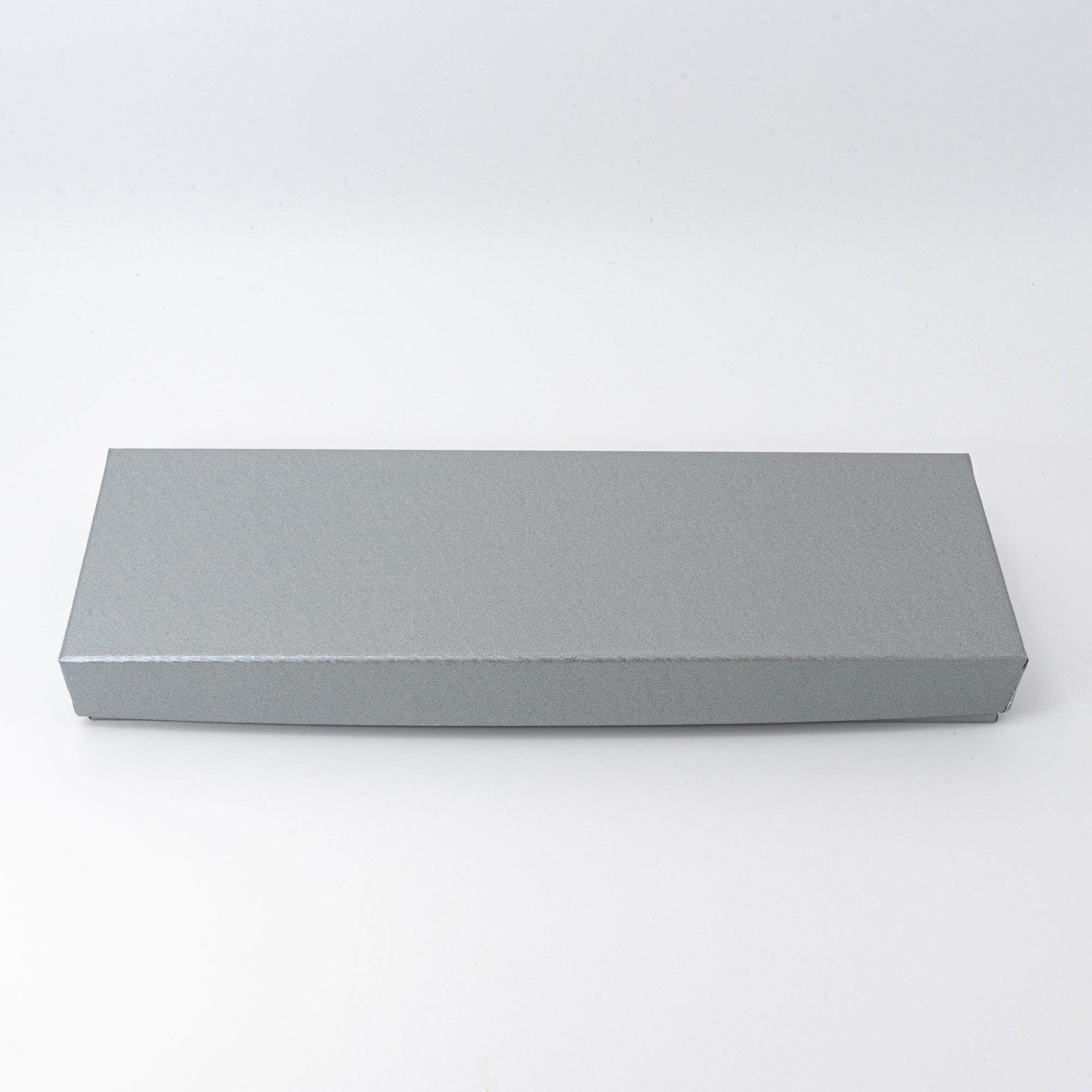 A silver-colored rectangular box, likely used for packaging the Japanese stationery tray.