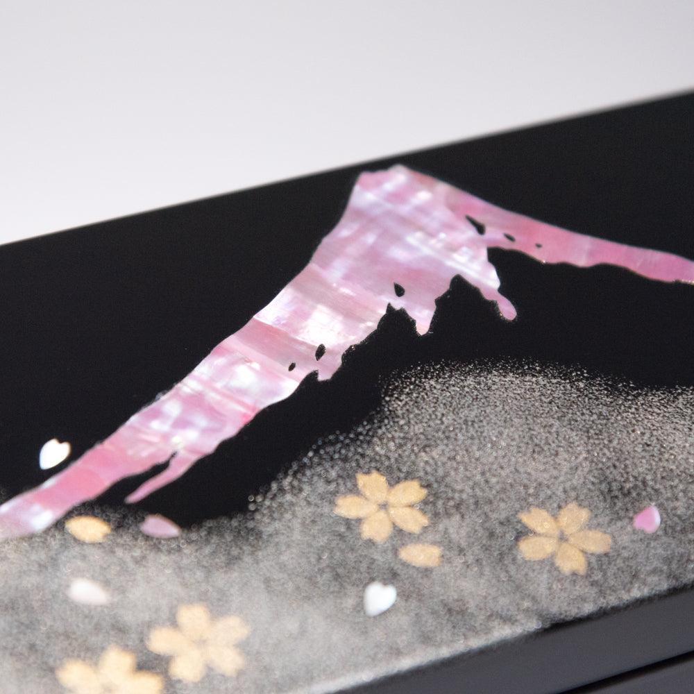 Close-up of raden Mt. Fuji on black lacquer pen box lid showing iridescent pink mother-of-pearl inlay and gold sakura