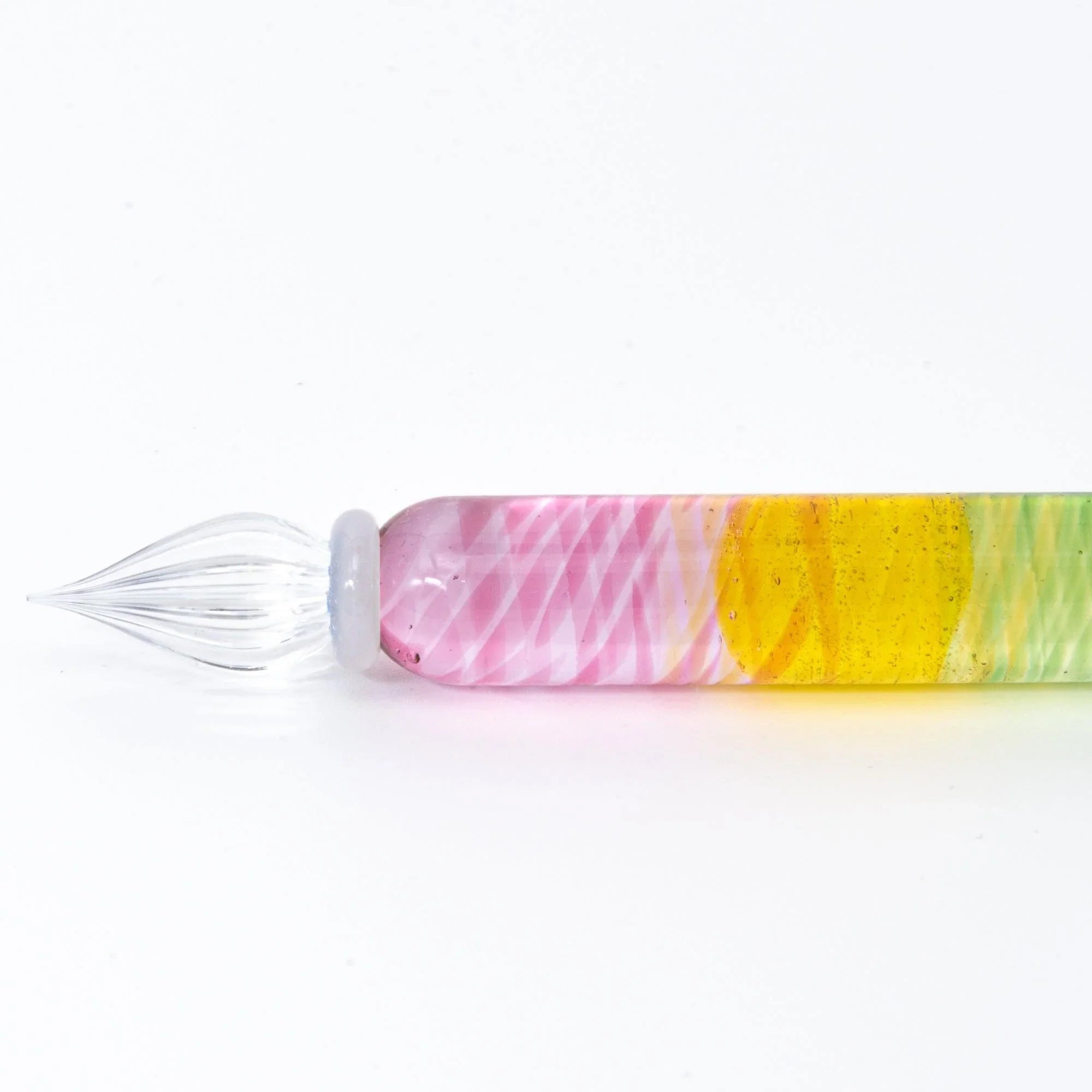 Rainbow Short glass dip pen nib and ferrule detail with multicolor striped handle visible in the background