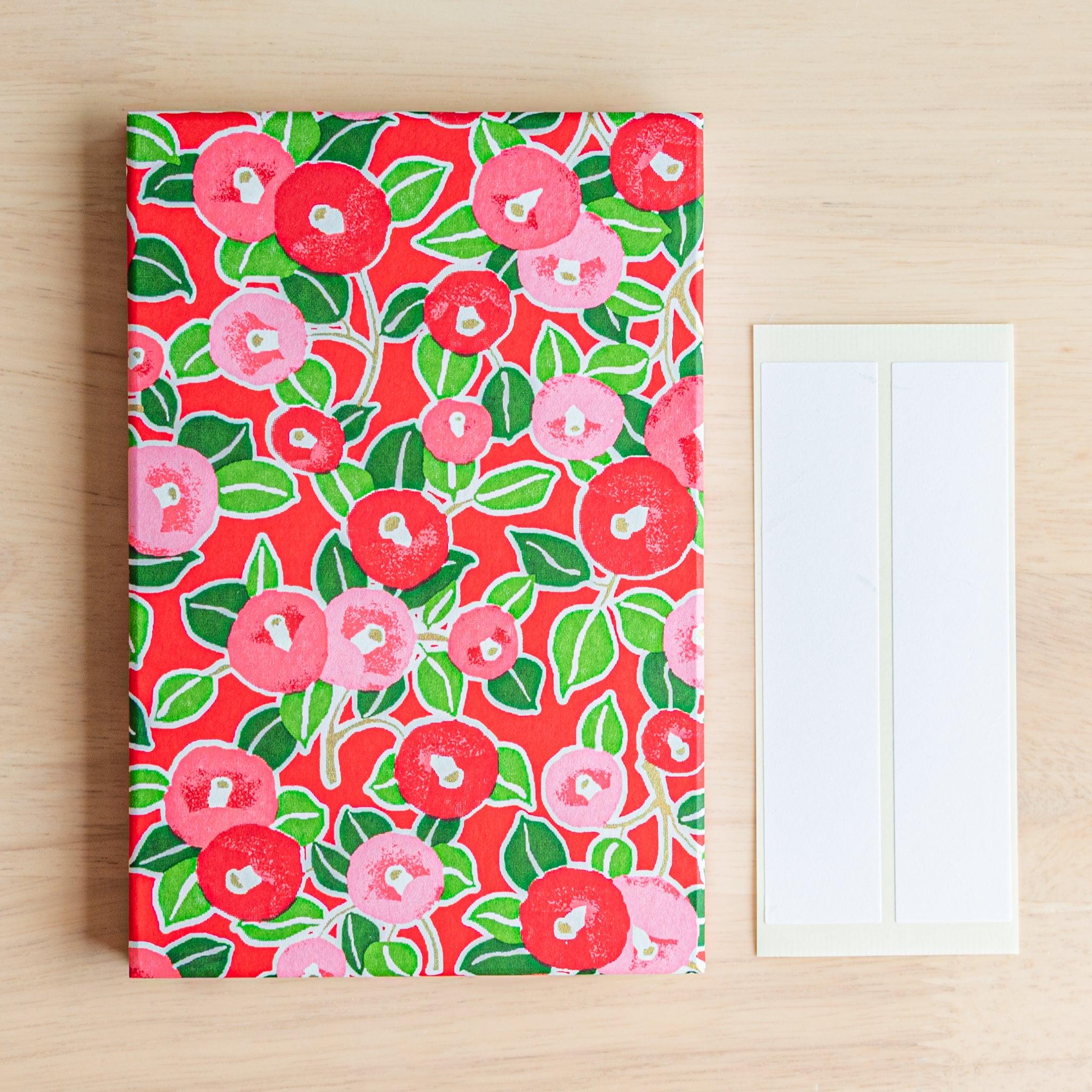 Red camellia Japanese Goshuinsho stamp book with name labels, perfect for collecting shrine or temple stamps.