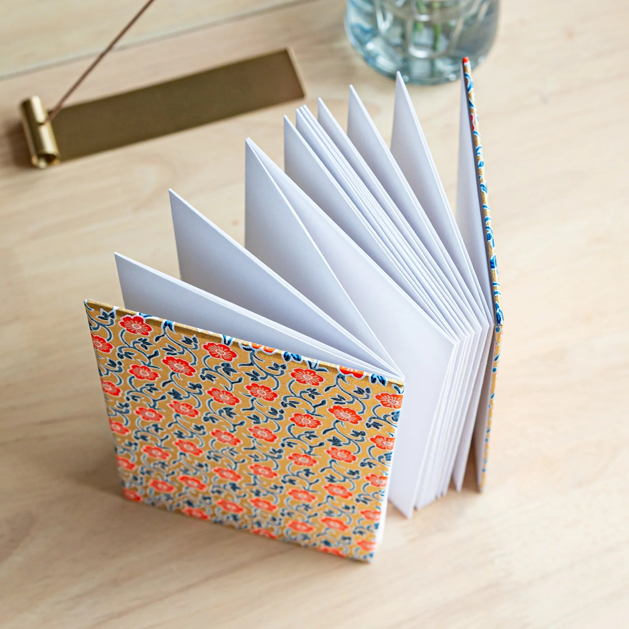 Red Flower Goshuincho accordion fold stamp book opened displaying red pages with flower motif throughout pages