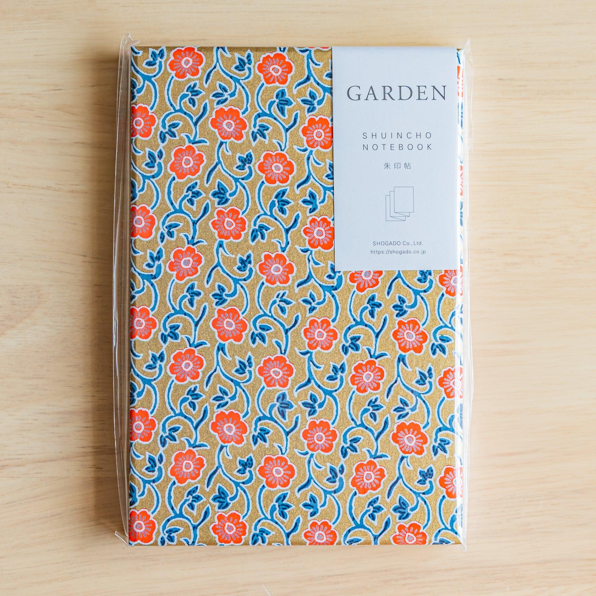 Red floral Goshuinsho stamp book in clear packaging, labeled SHUINCHO NOTEBOOK by SHOGADO of Japan.