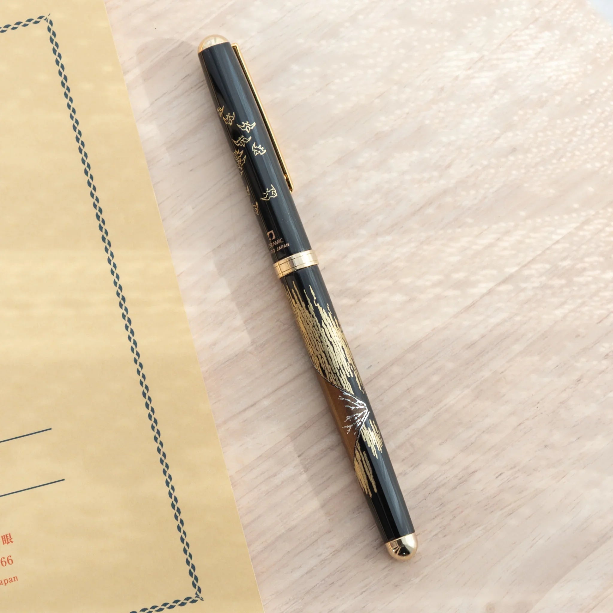 Red Fuji Yamanaka ballpoint pen displays hand-painted lacquer Mount Fuji sunset landscape detail for writing