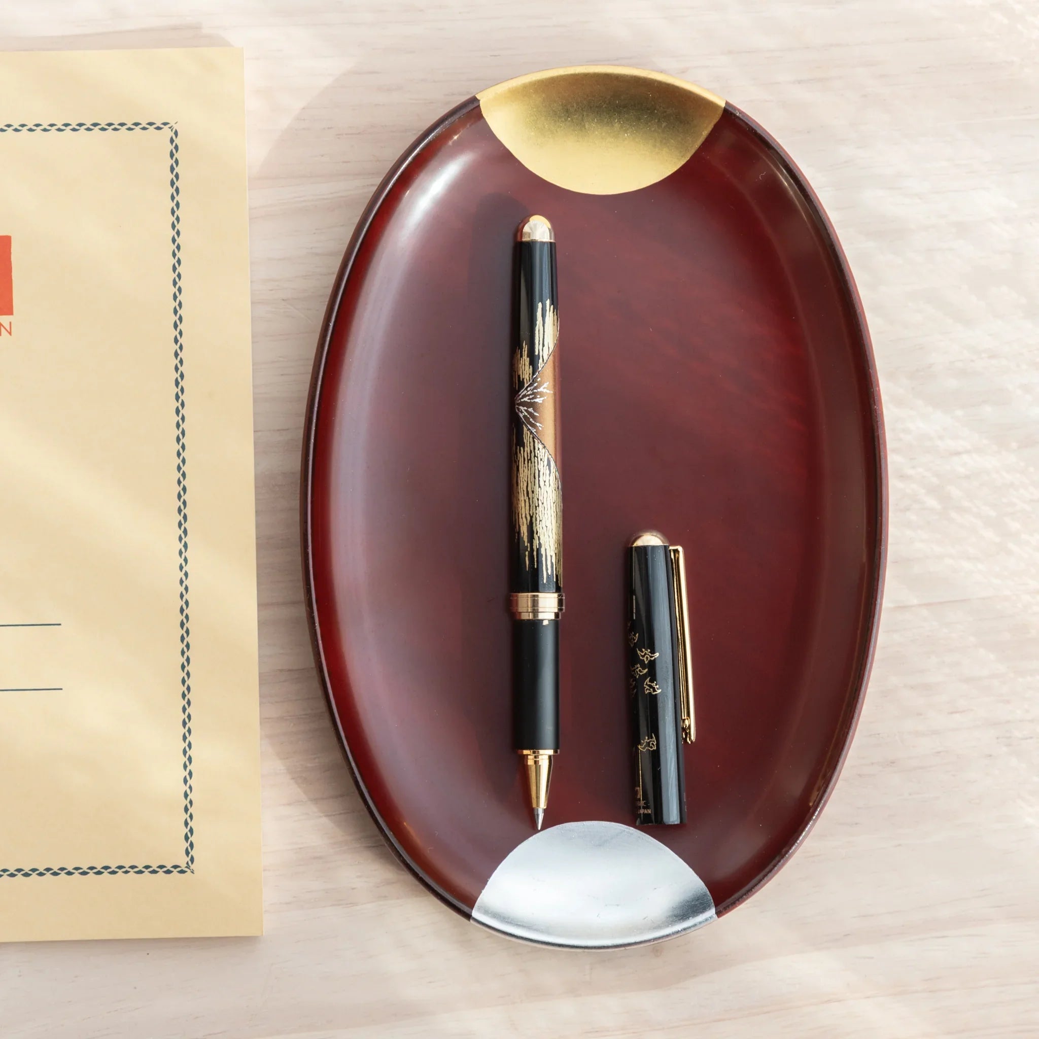 Red lacquer Yamanaka ballpoint pen features detailed Mount Fuji and landscape scenery design art for writing