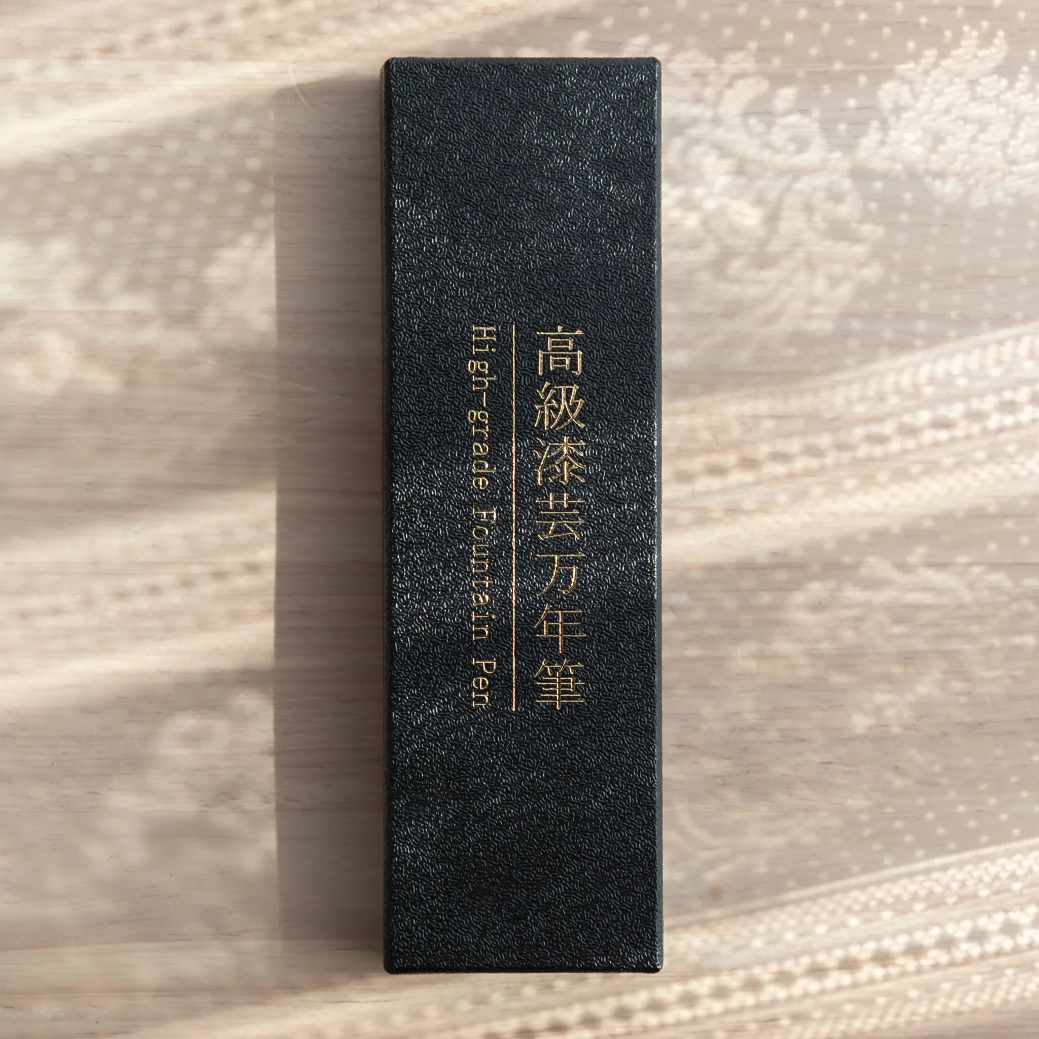 Yamanaka made fountain pen displays seascape wave artwork with metallic silver accents for writing, Japan lacquer