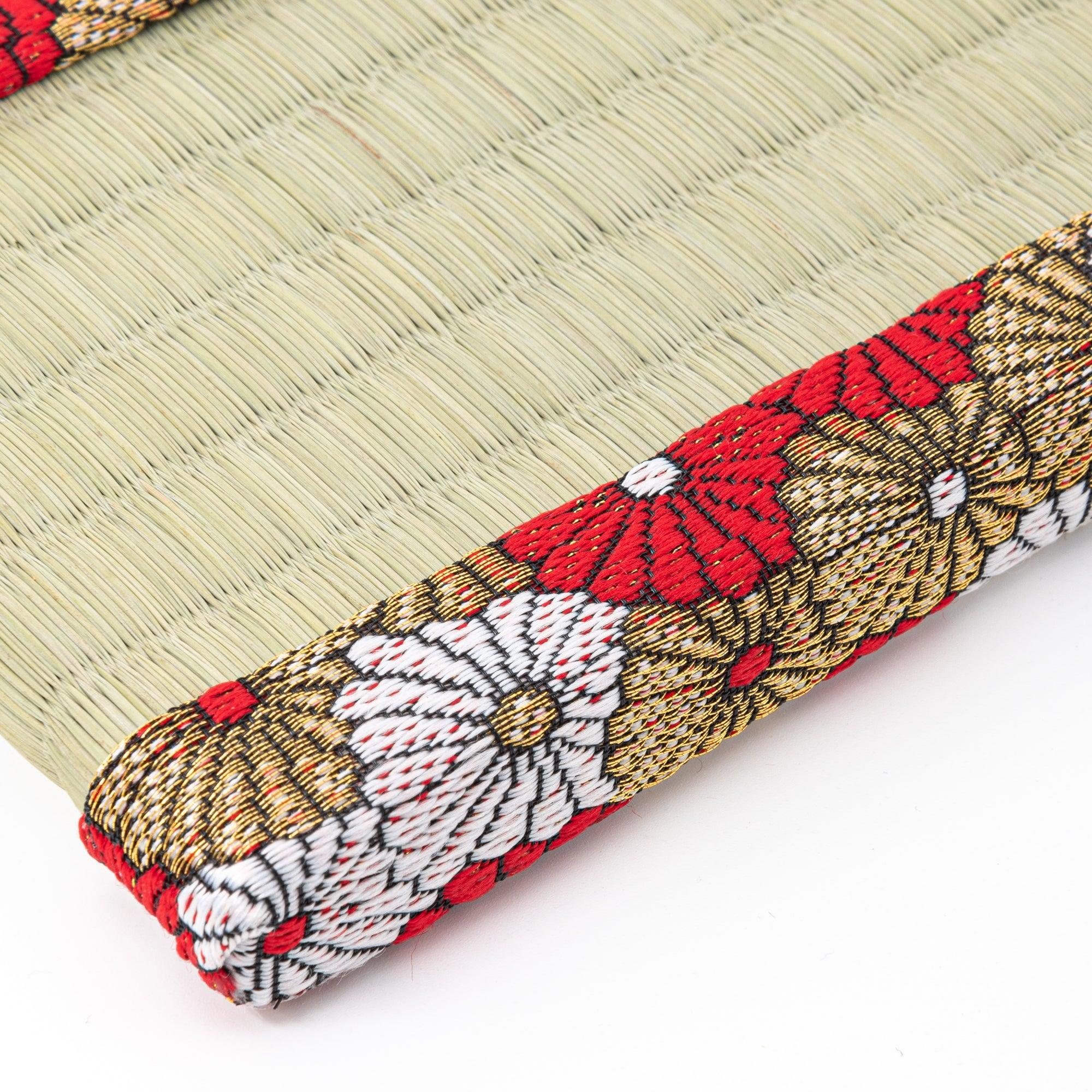 Corner detail of Japanese tatami pen tray showing chrysanthemum brocade border wrapping around the rounded edge