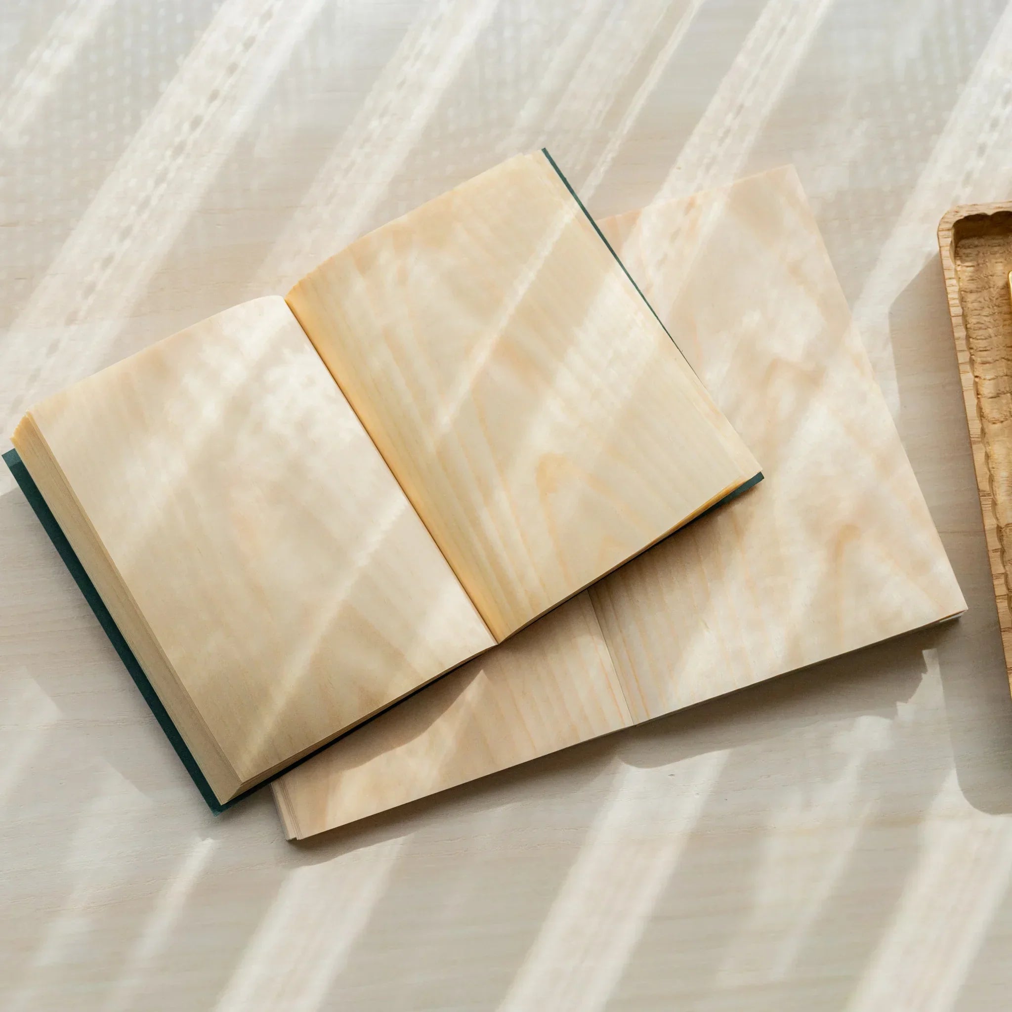 Red Pine wood-paged B6 journal, stacked position showing cover thickness and grain pattern texture showing natural wood