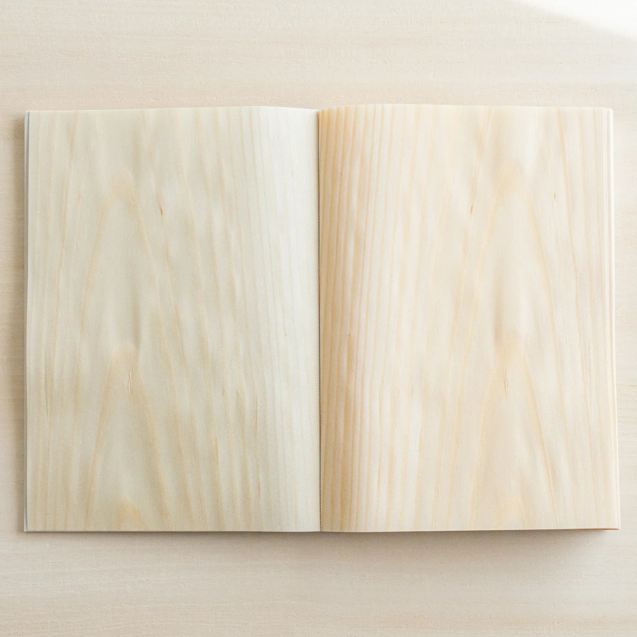 Red Pine wood-paged B6 journal, back view with wooden page construction detail and binding craft showing natural wood