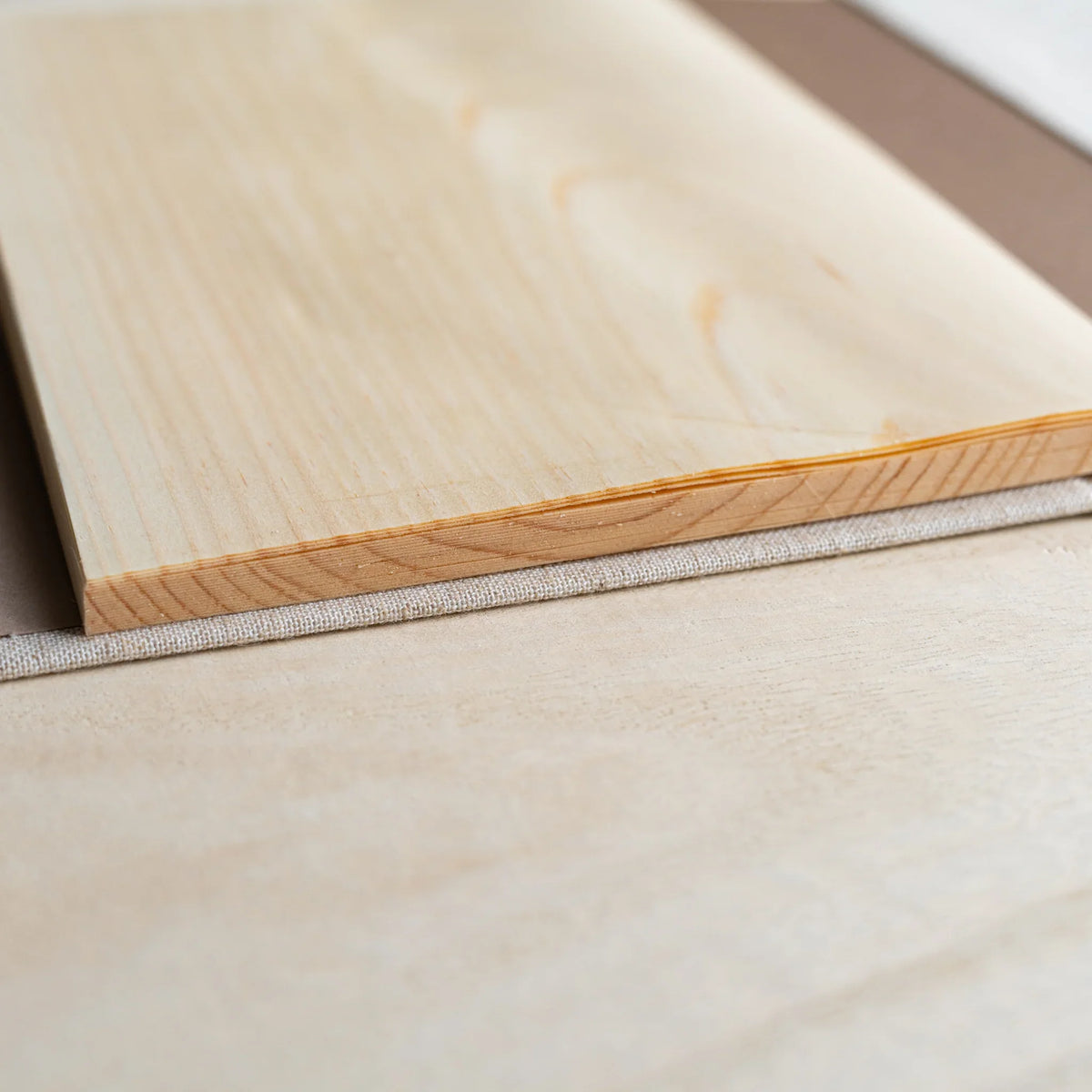 Close-up of the wood sheet page block edge of the Red Pine Wooden Page Sketchbook on a linen cover