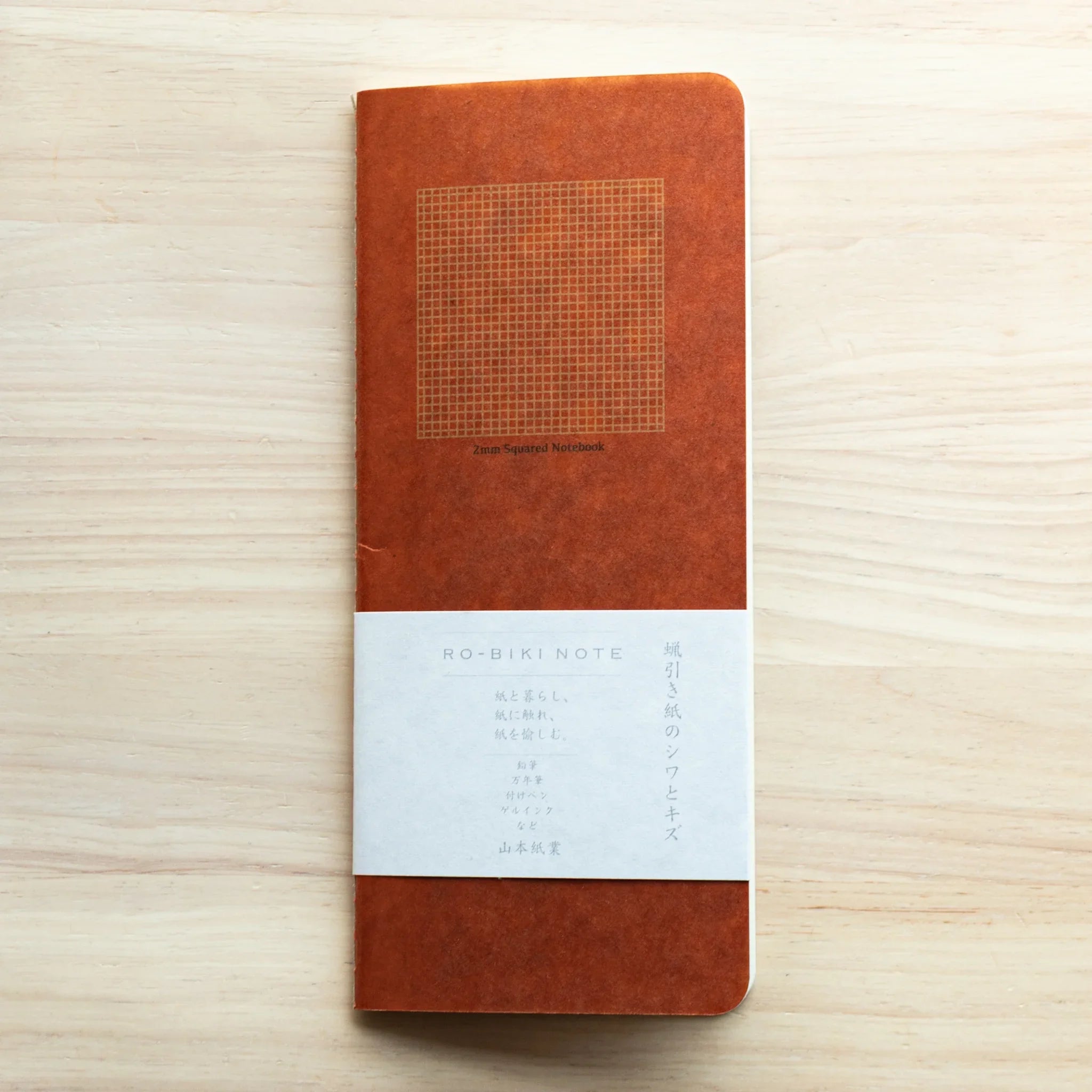 RO-BIKI Basic Series notebook with 2mm grid ruling displayed flat on white surface, showing slate blue cover design