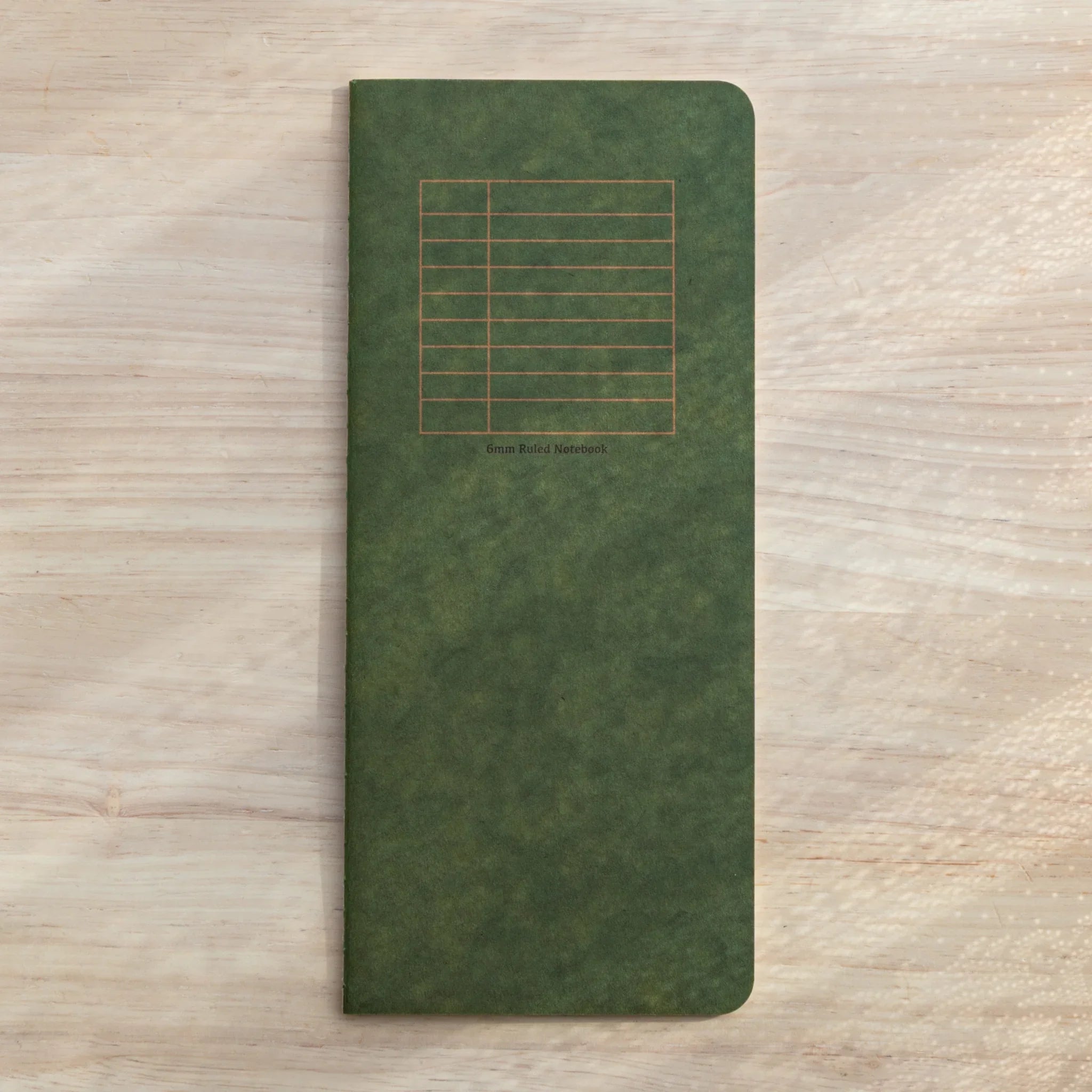 RO-BIKI Basic Series 6mm ruled notebook shown flat on surface displaying cover and structured line layout