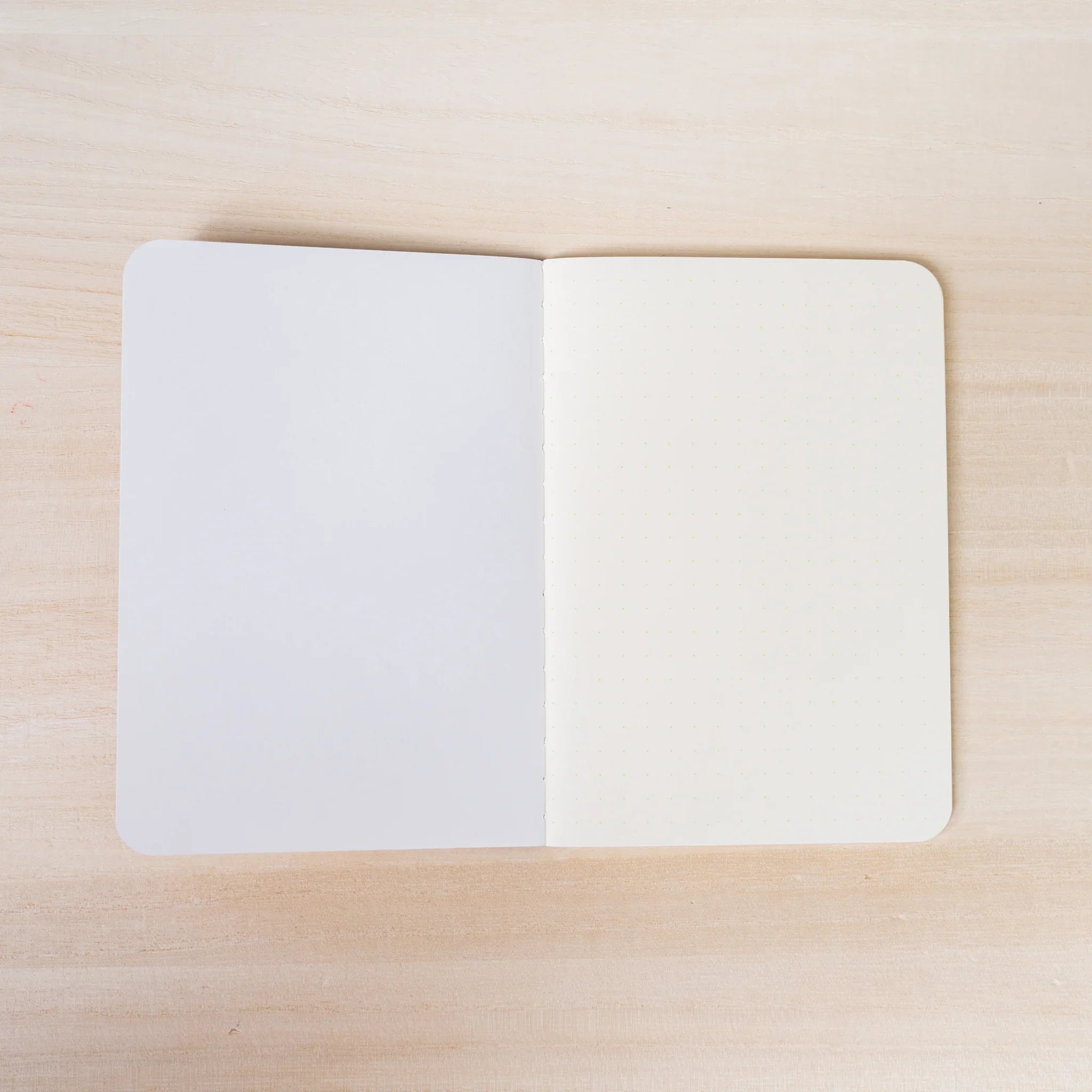 RO-BIKI NOTE open flat, blank white page on left, ivory page on right, rounded corners and center spine visible