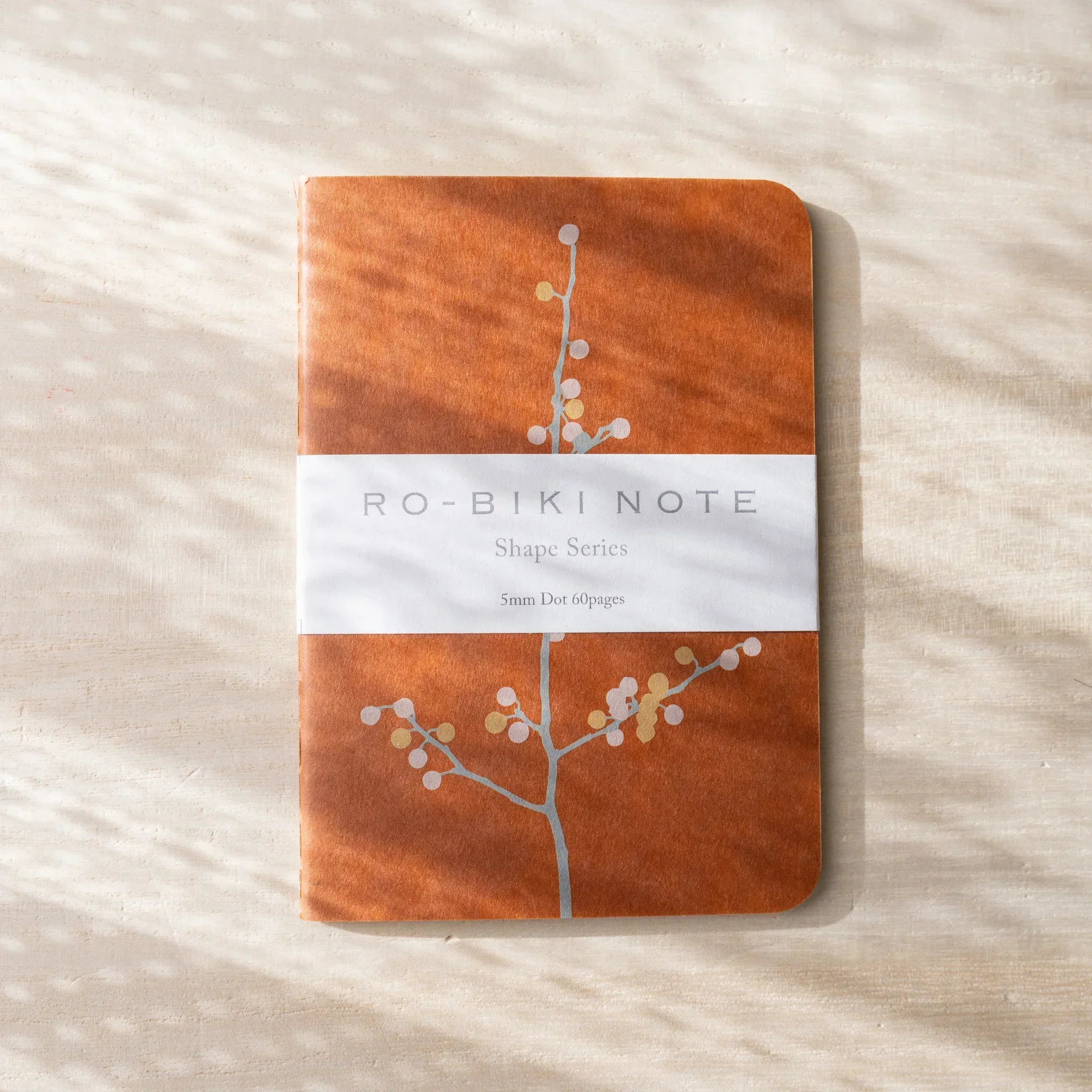 RO-BIKI NOTE Japanese notebook with terracotta waxed kraft cover showing branch and flowers, belly visible