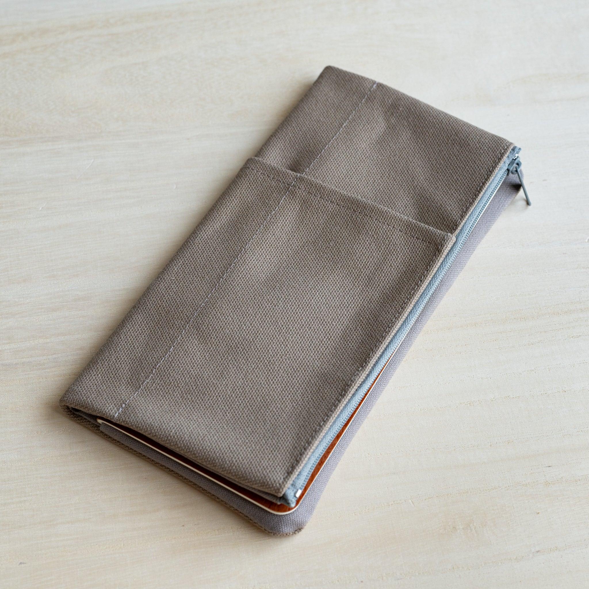 RO-BIKI clay beige canvas cover closed over a tan notebook, shown at an angle with the side zip