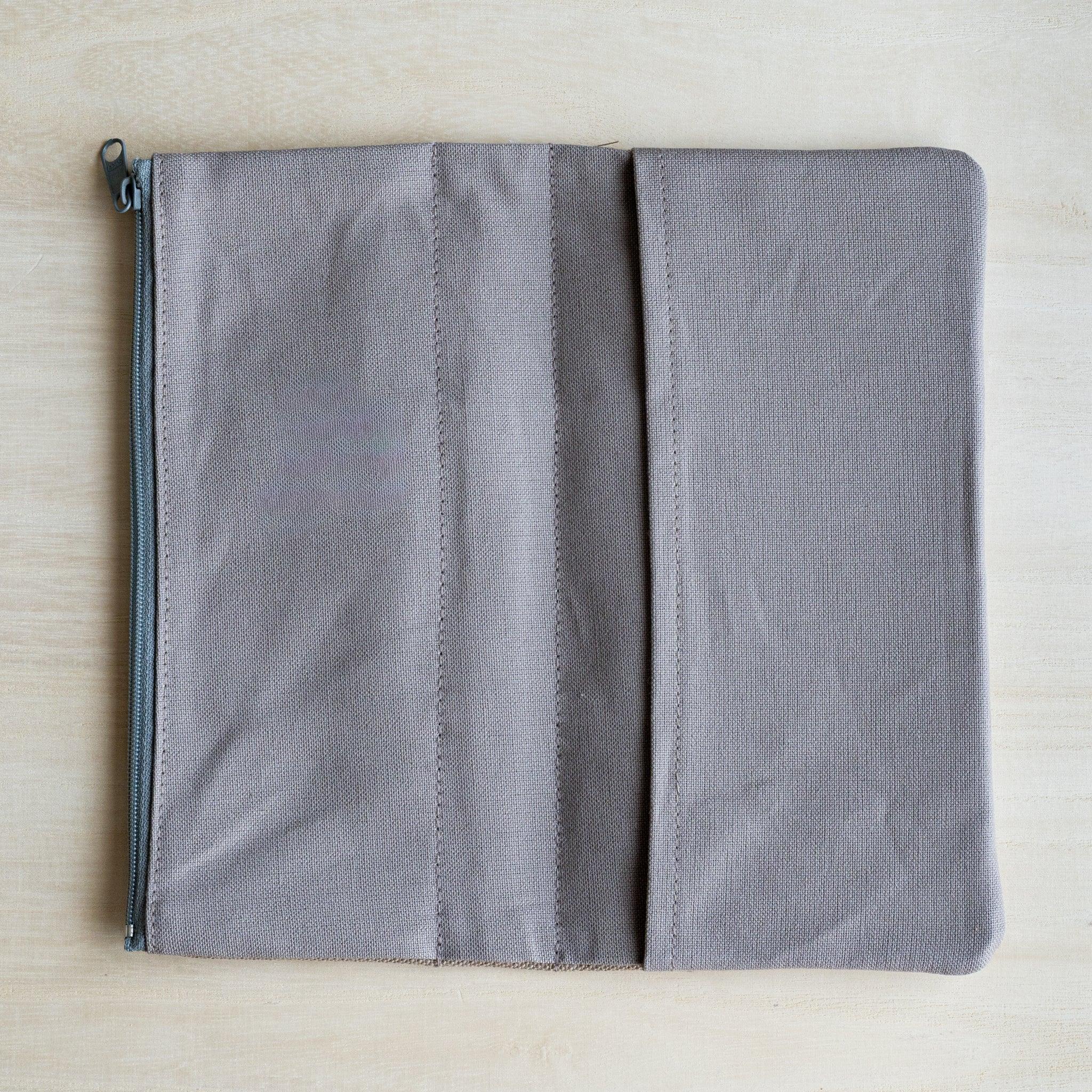RO-BIKI clay beige canvas cover opened flat, showing the grey cotton lining and the inner holding flaps