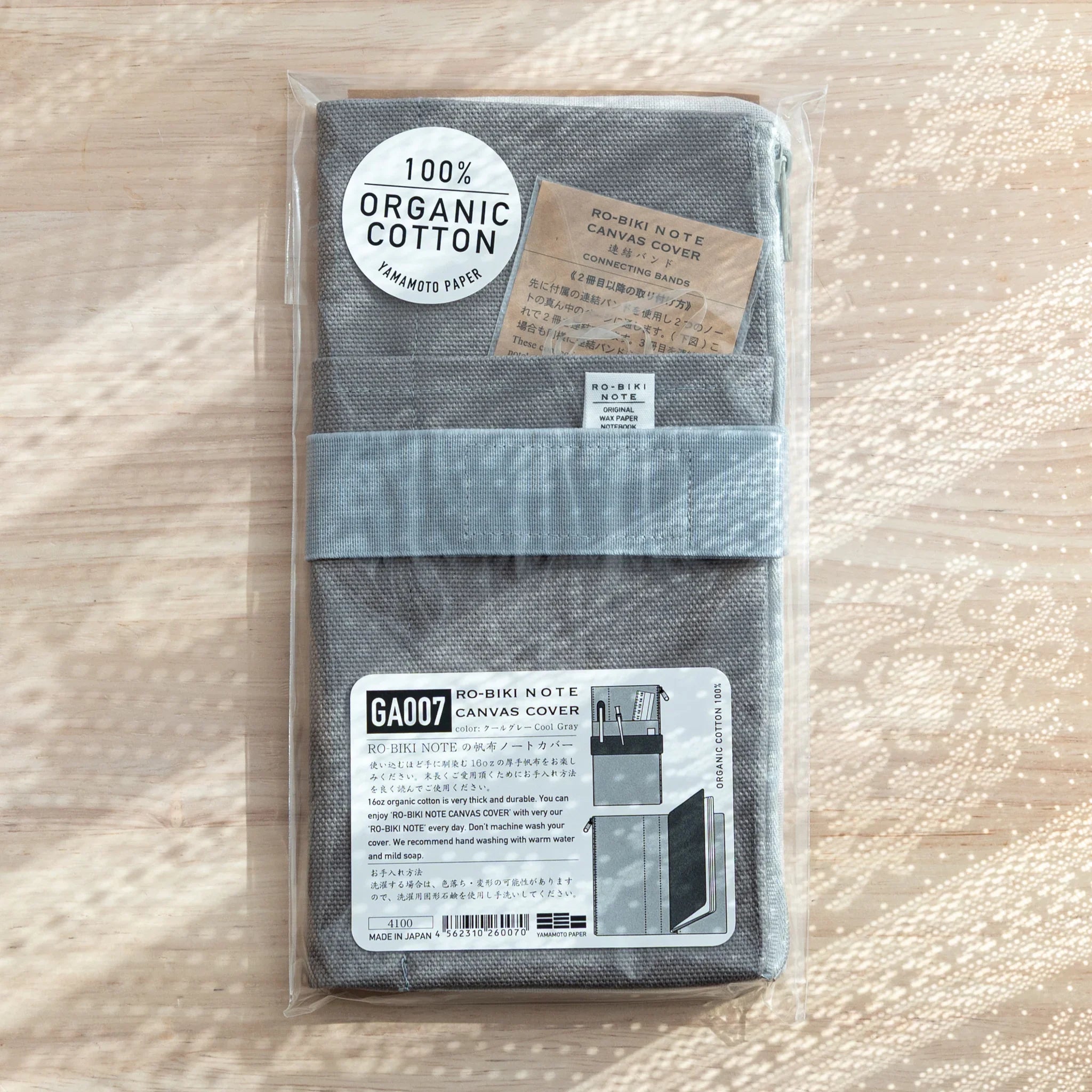 RO-BIKI Canvas Cover in cool gray displayed showing front cover with integrated stationery pocket detail, Japanese organizer