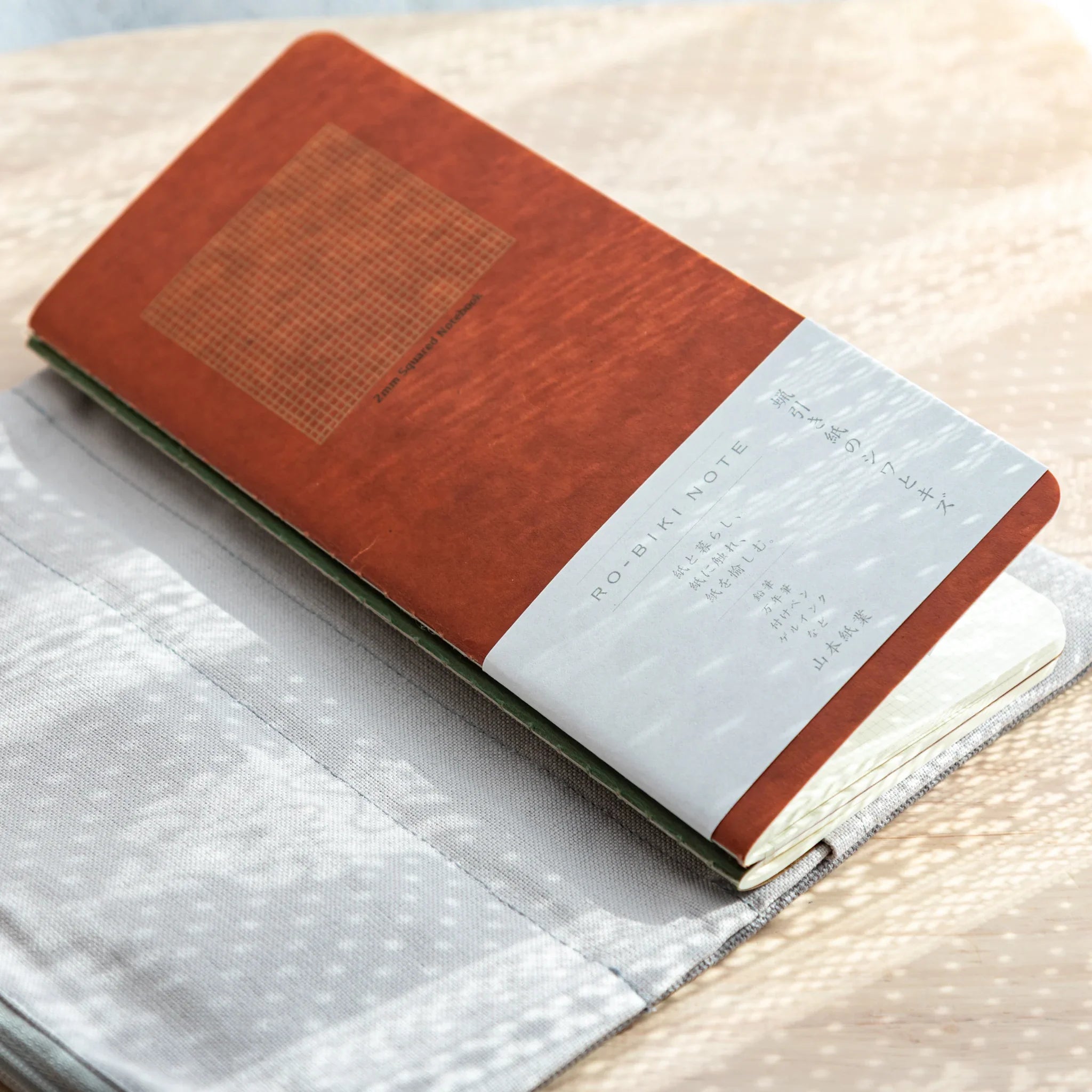 RO-BIKI Japanese Note Book brown cover visible inside Cool Gray canvas cover, slim and stylish design.