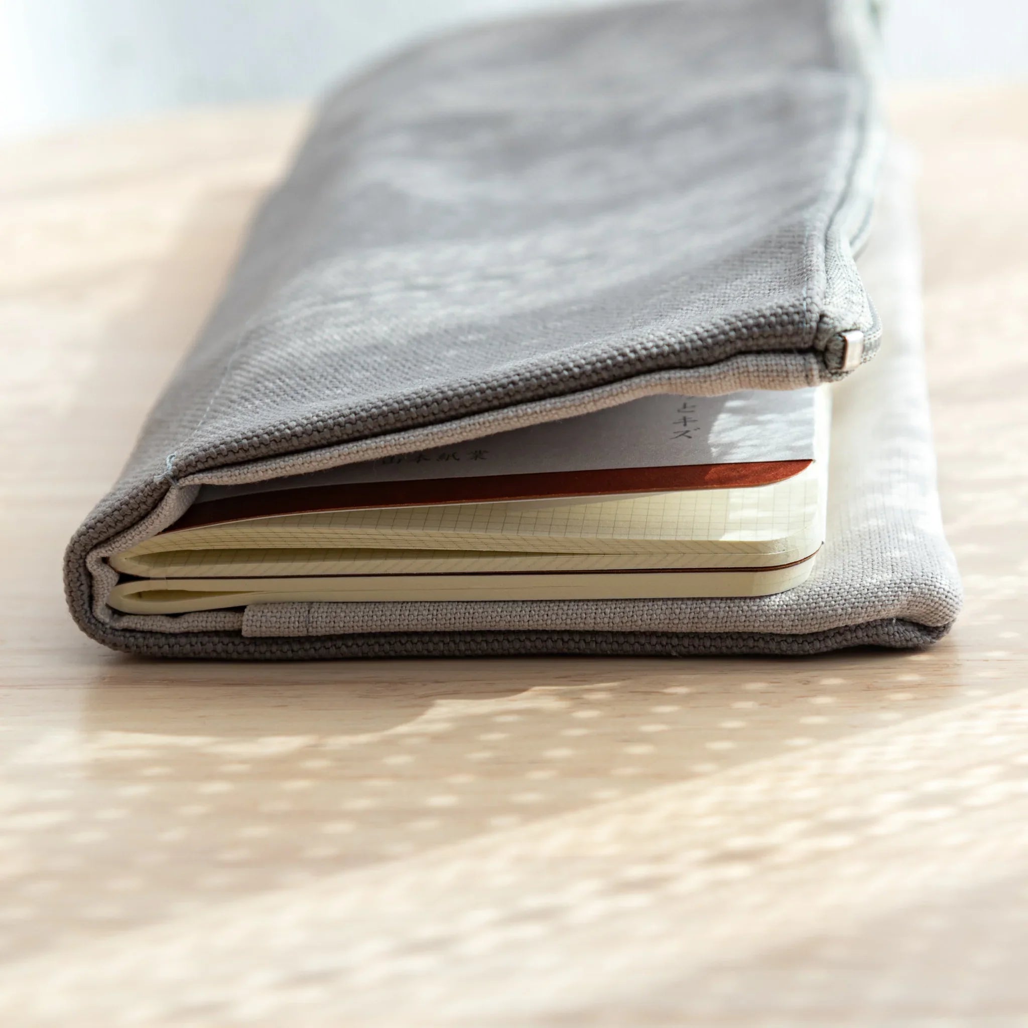 RO-BIKI Canvas Cover in cool gray displayed showing pocket and front design, organization tool with craftsmanship