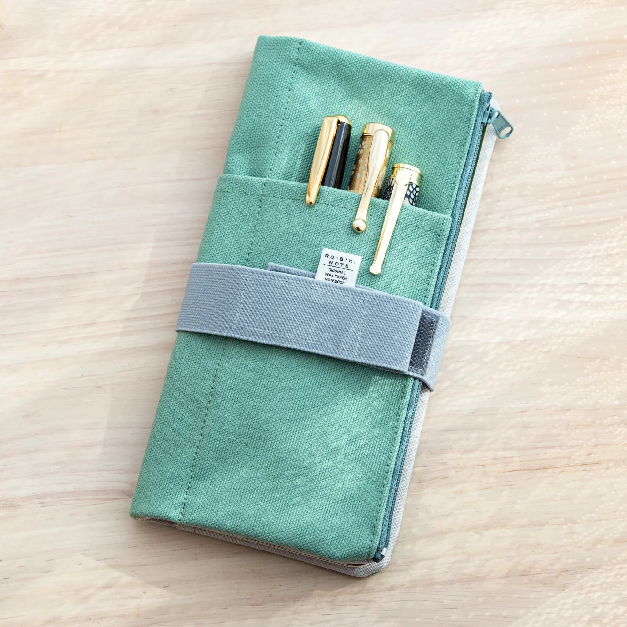 Japanese Note Book Cover RO-BIKI Canvas Cover – Mint Green with stationery pocket holding pens.