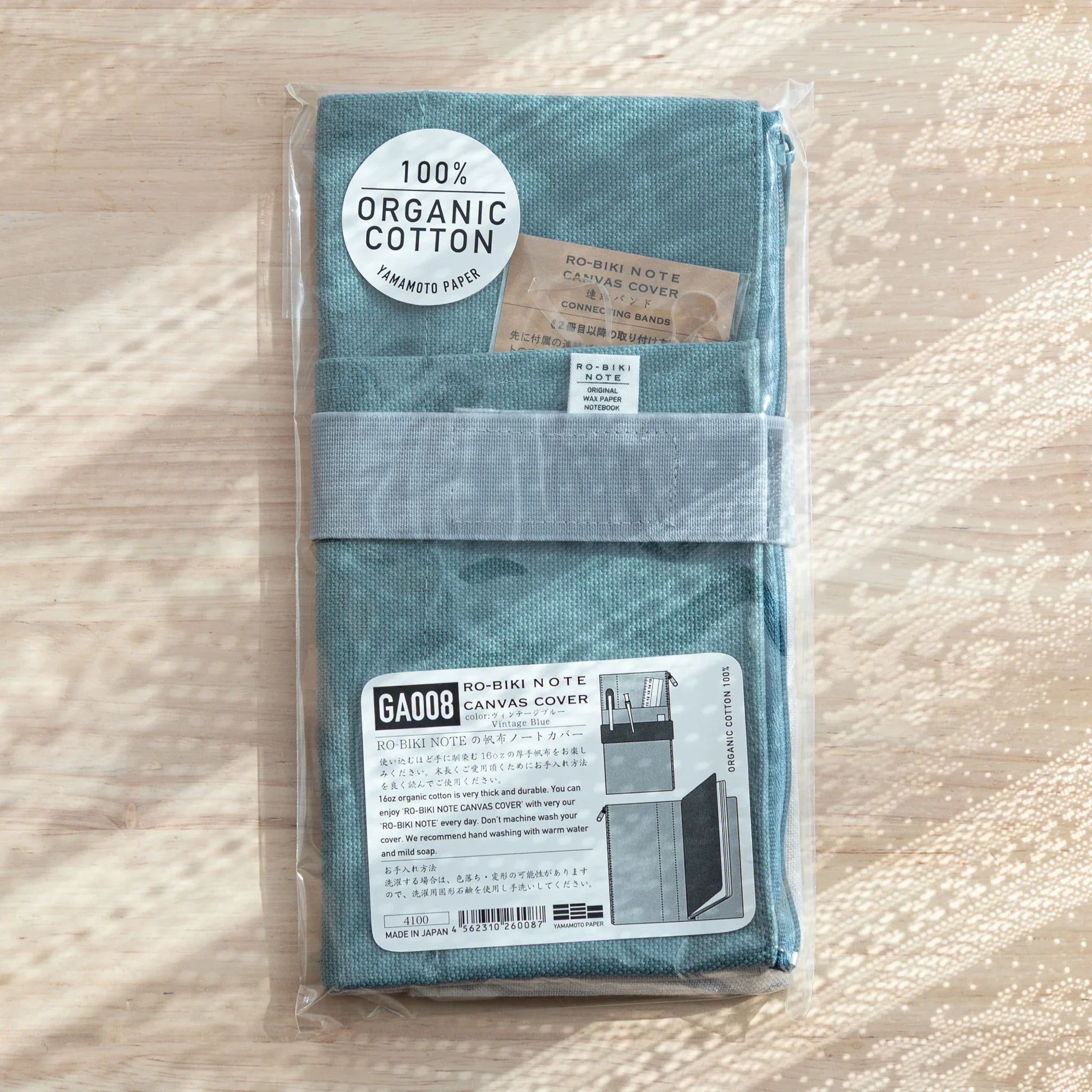 RO-BIKI Canvas Cover in vintage blue displayed showing front cover with integrated stationery pocket, organization accessory