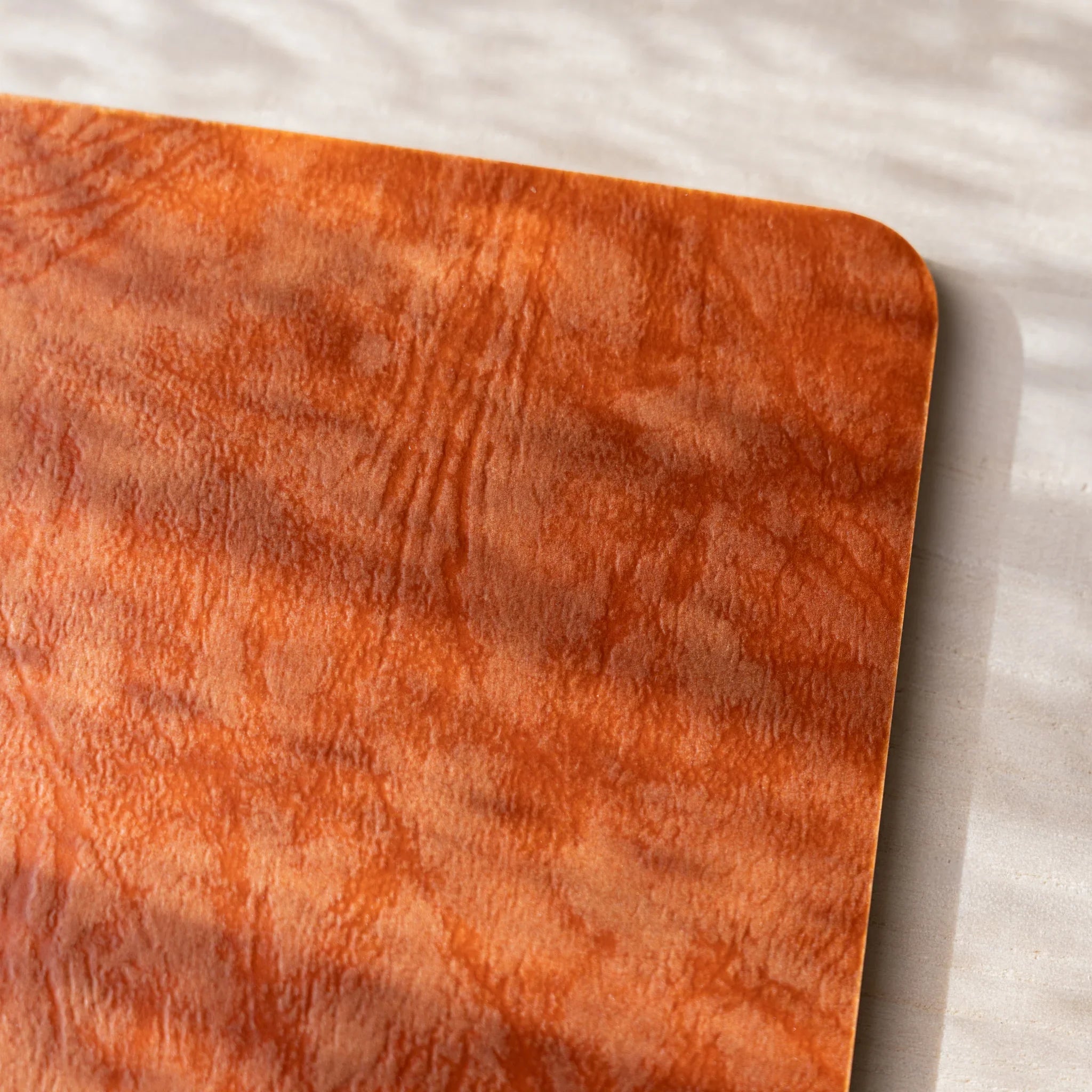 Close-up macro detail of RO-BIKI NOTE Edocha Brown wax-coated cover showing unique paraffin wax texture pattern