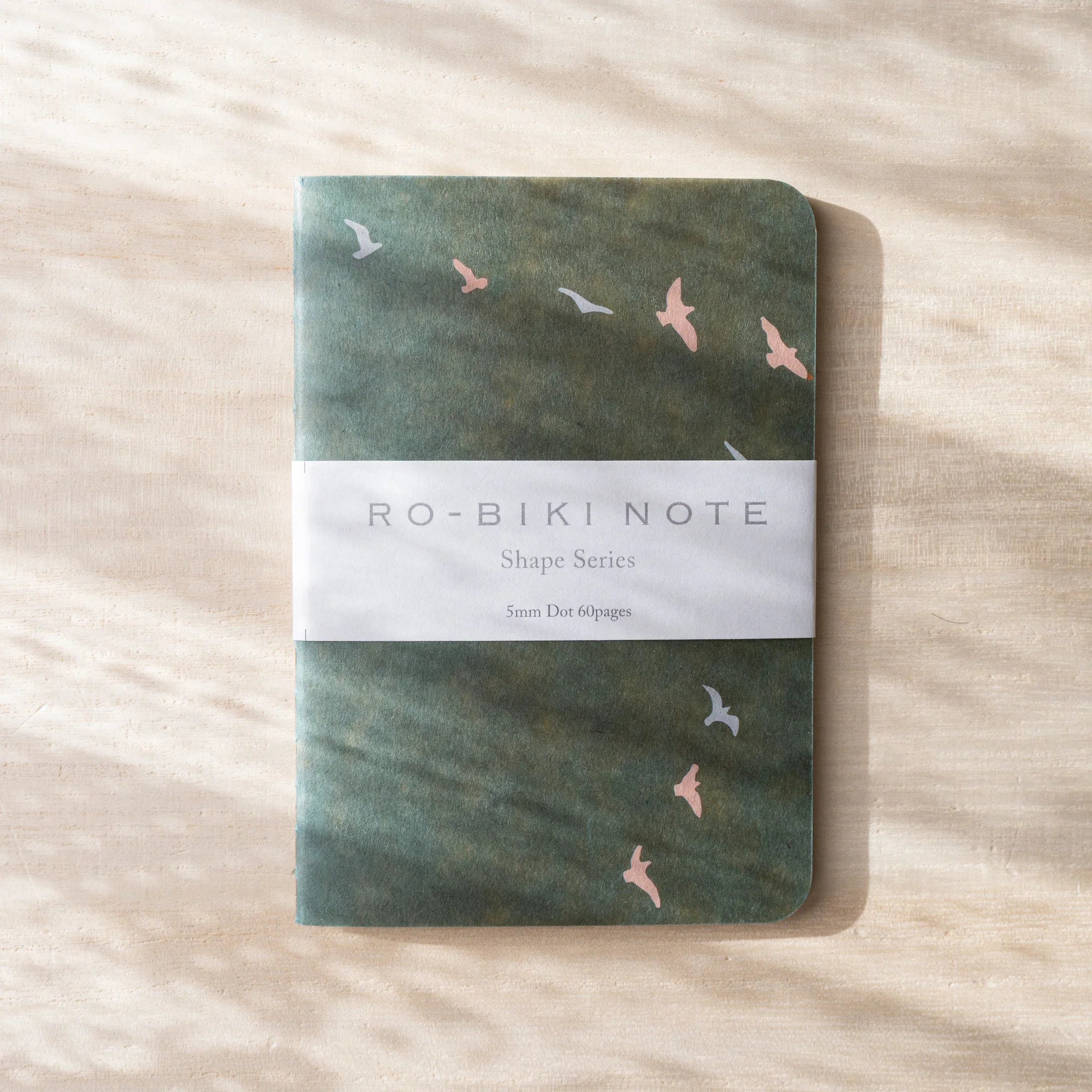 RO-BIKI NOTE Japanese notebook, sage green waxed cover with flying bird silhouettes, paper belly band with Shape Series text
