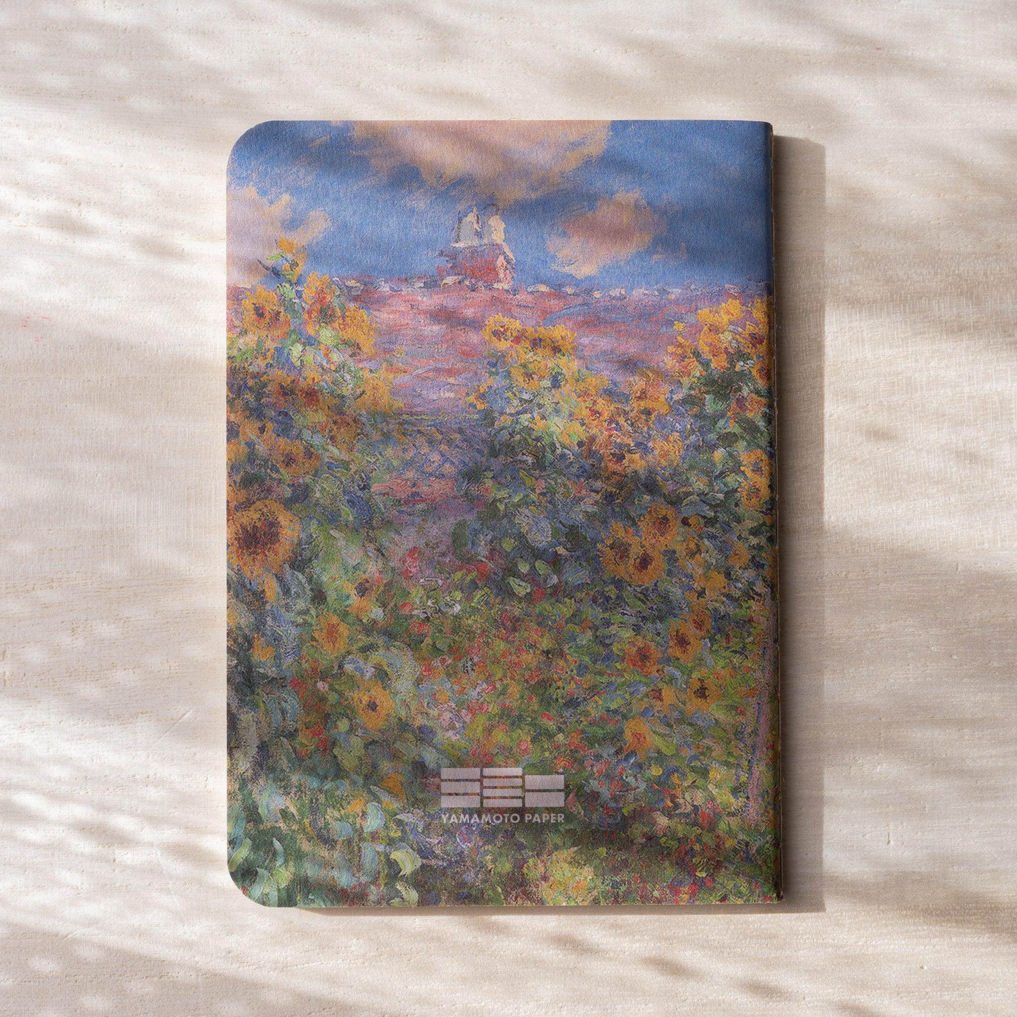 RO-BIKI NOTE stacked closed, showing waxed cover with garden floral design, rounded corners, layered view