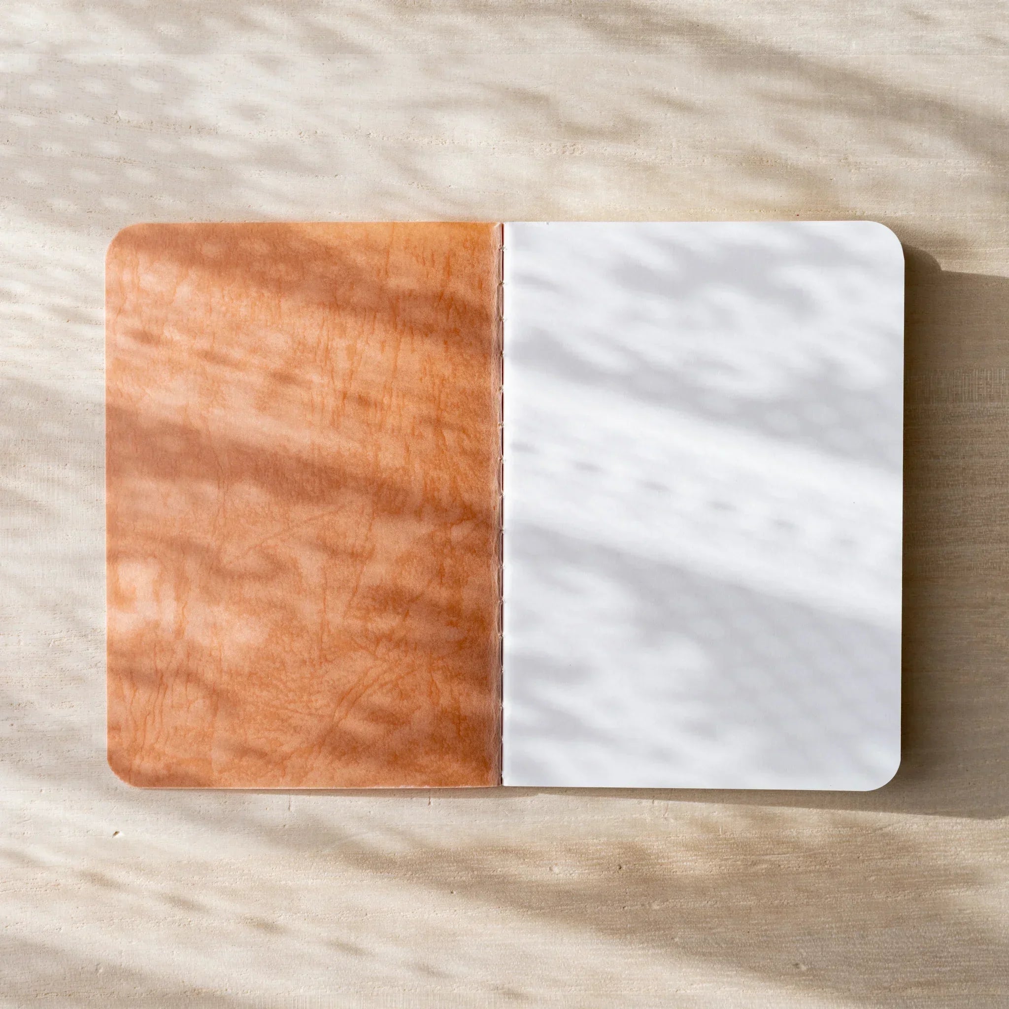 RO-BIKI NOTE open to cream blank page spread, rounded corners and center spine visible, clean paper texture