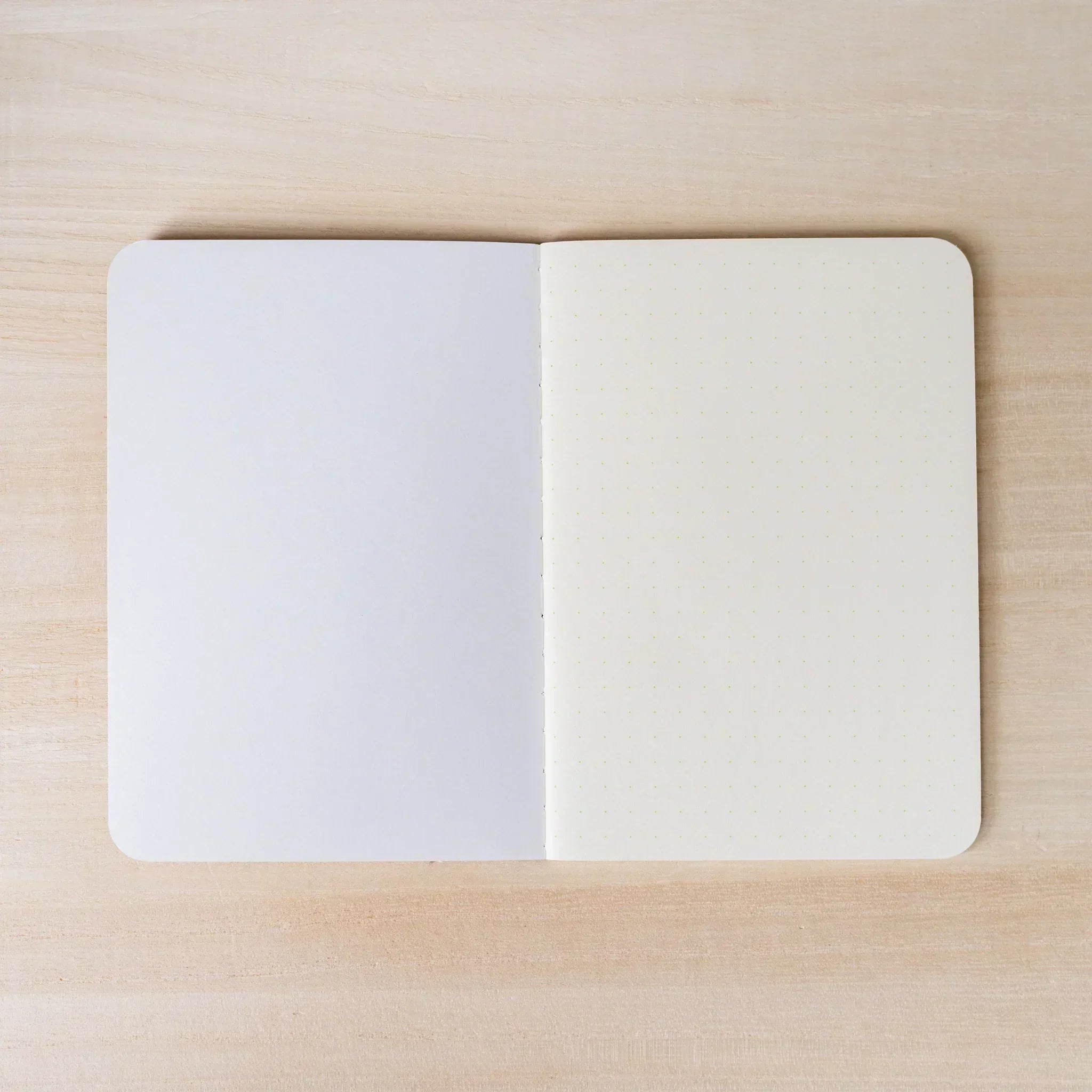 RO-BIKI NOTE open flat, blank white page on left, ivory dot grid page on right, rounded corners and spine