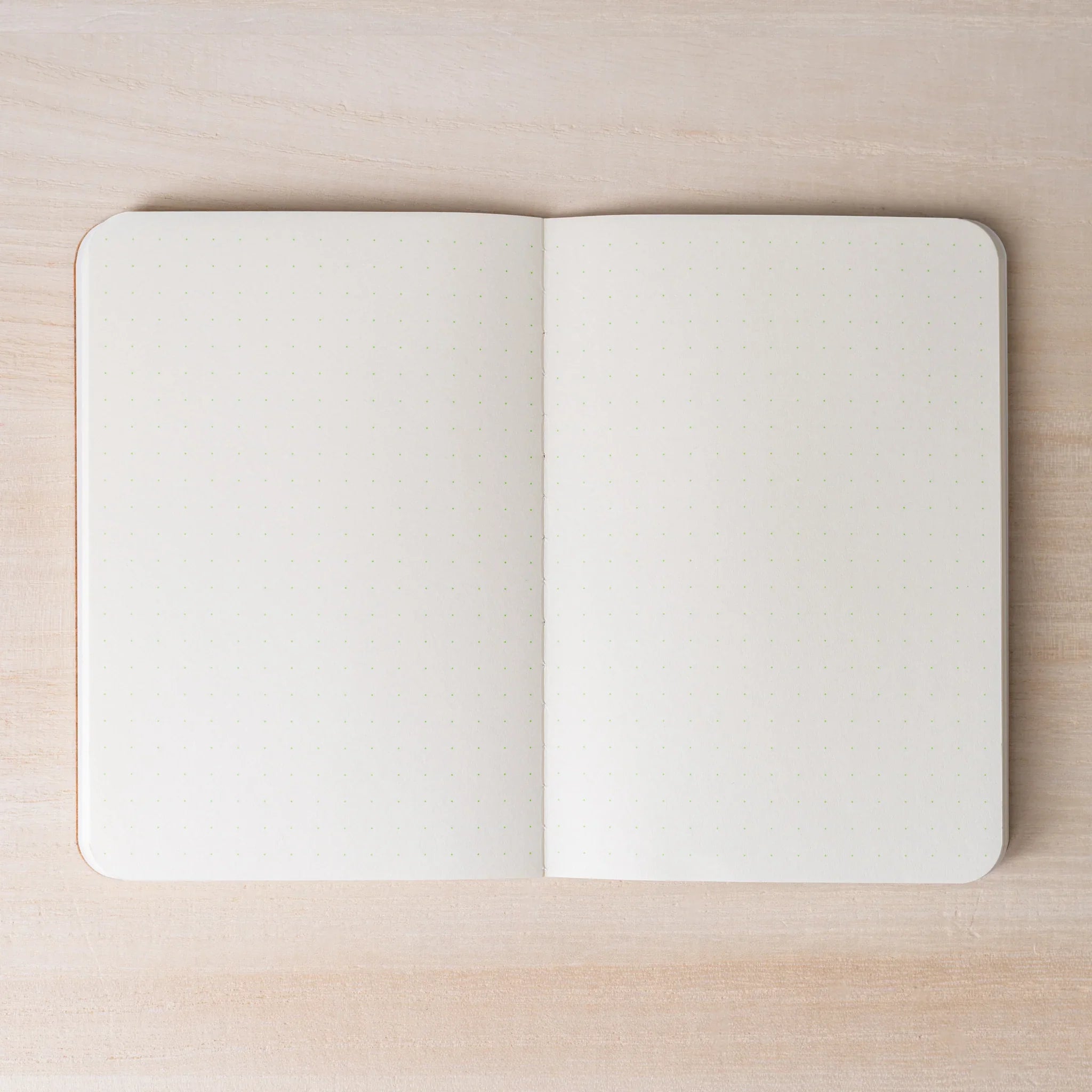 RO-BIKI NOTE open to ivory dot grid spread, both pages with 5mm dot pattern, rounded corners and center spine visible