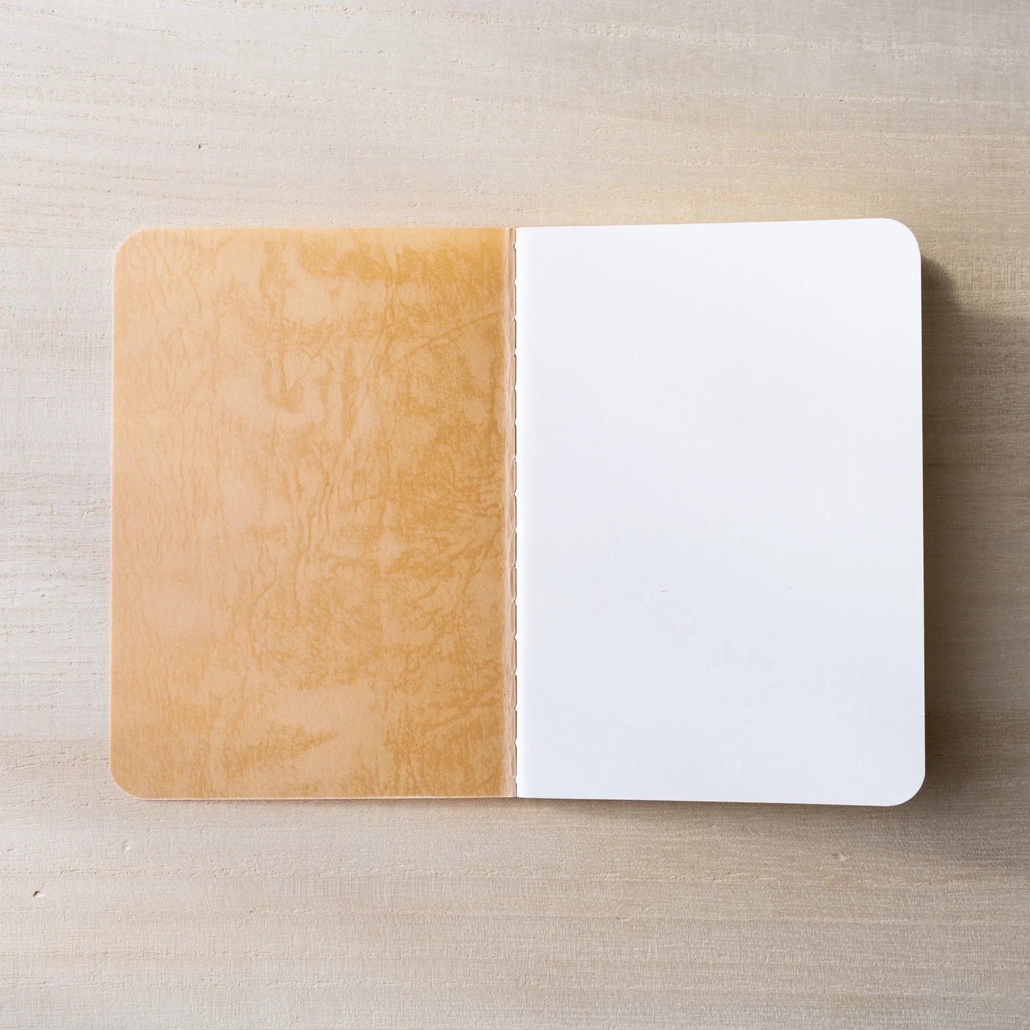 RO-BIKI NOTE open to cream blank page spread, rounded corners and center spine visible, clean paper texture