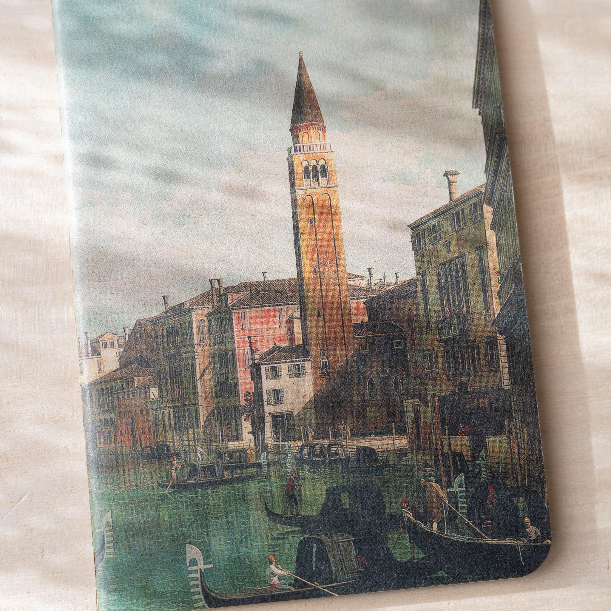 Close-up of RO-BIKI NOTE waxed cover showing Venetian canal painting with bell tower, buildings, and gondolas, no belly band