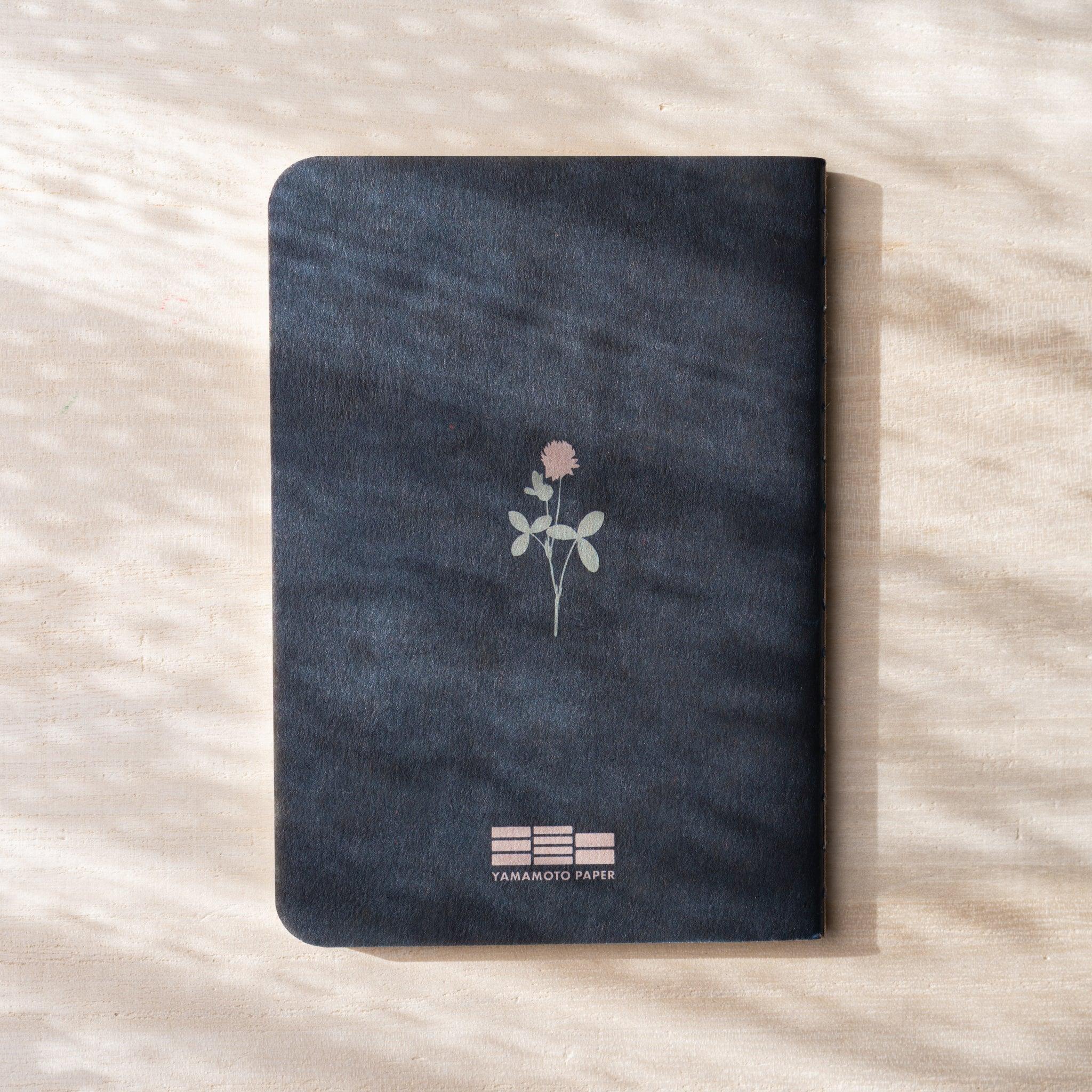 RO-BIKI NOTE Japanese notebook back cover, dark navy waxed cover with botanical flower illustration, Yamamoto Paper logo