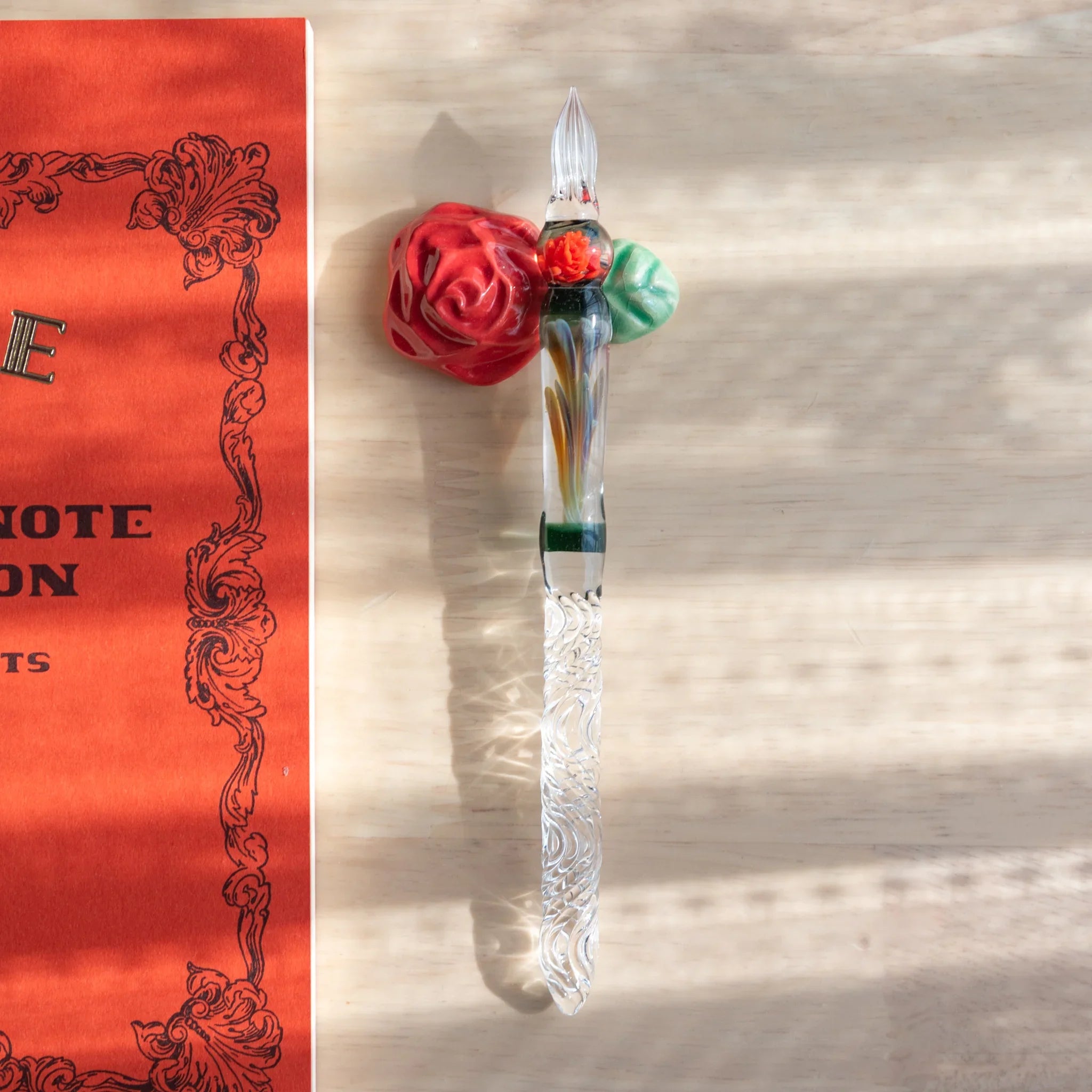 Red rose handcrafted ceramic pen rest with green leaves and traditional ceramic handcrafted design element detail
