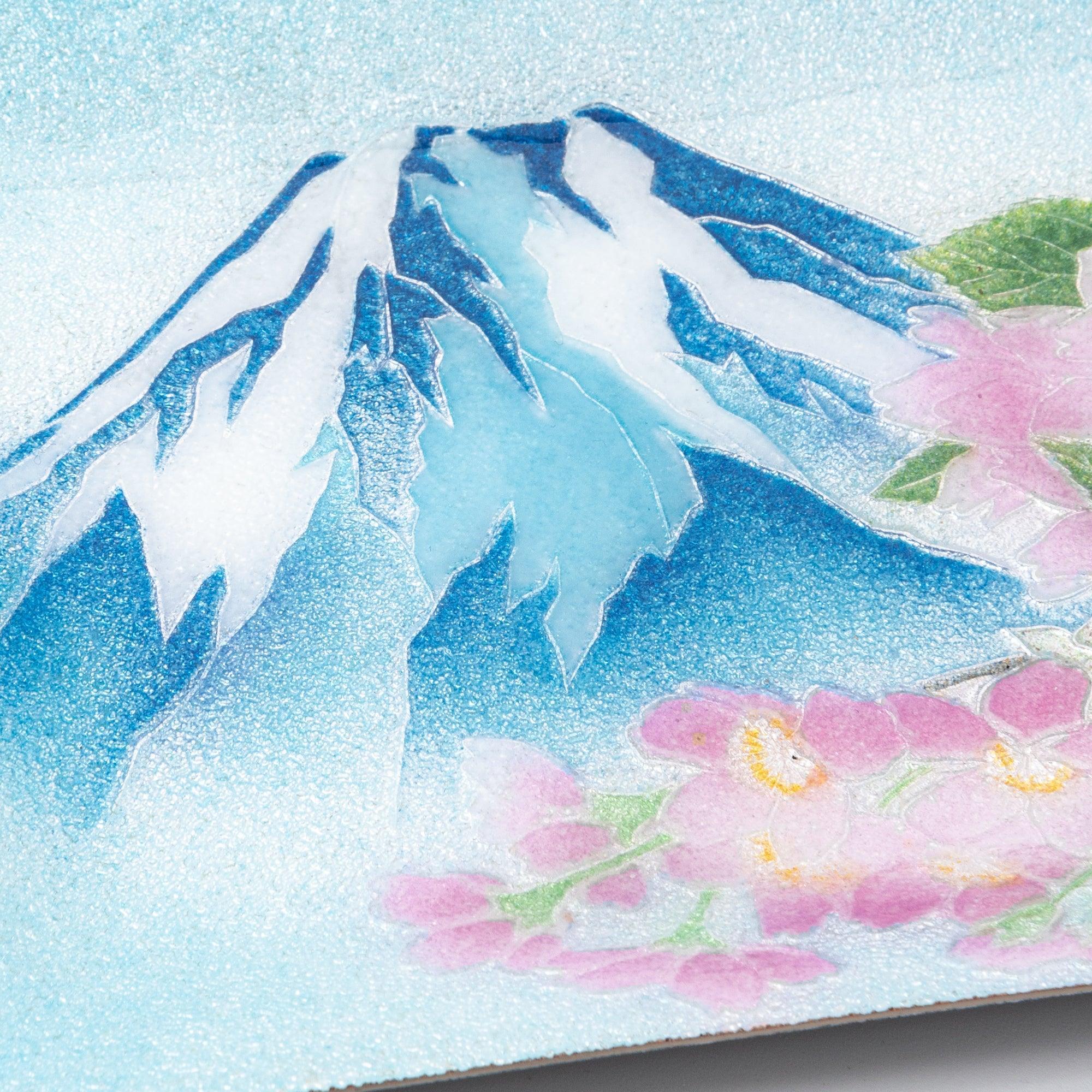 Close-up of Japanese shippo ware pen tray surface showing granular enamel texture, Mt. Fuji and pink sakura blossoms