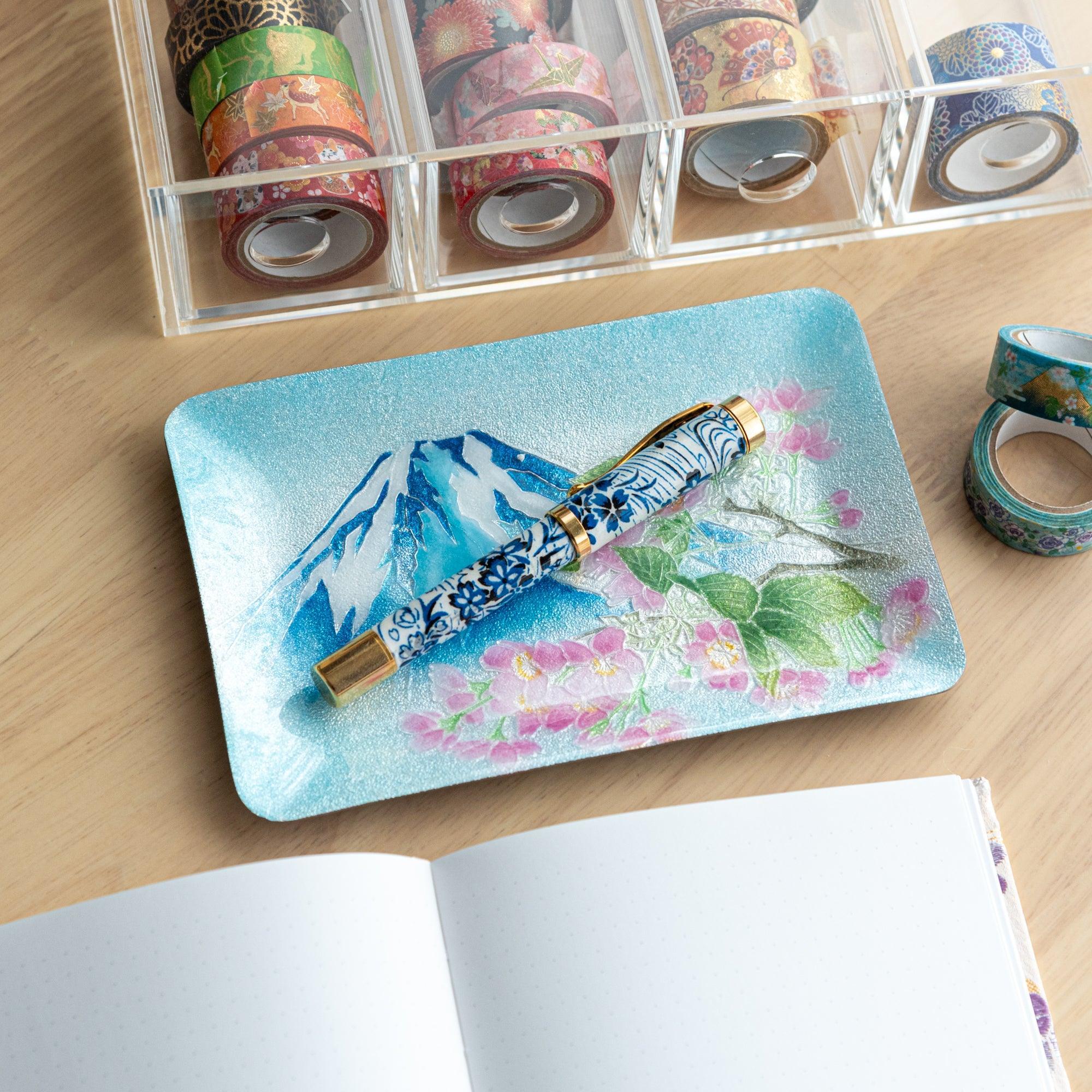 Japanese shippo ware pen tray with blue enamel Mt. Fuji and sakura design, blue floral fountain pen resting on tray