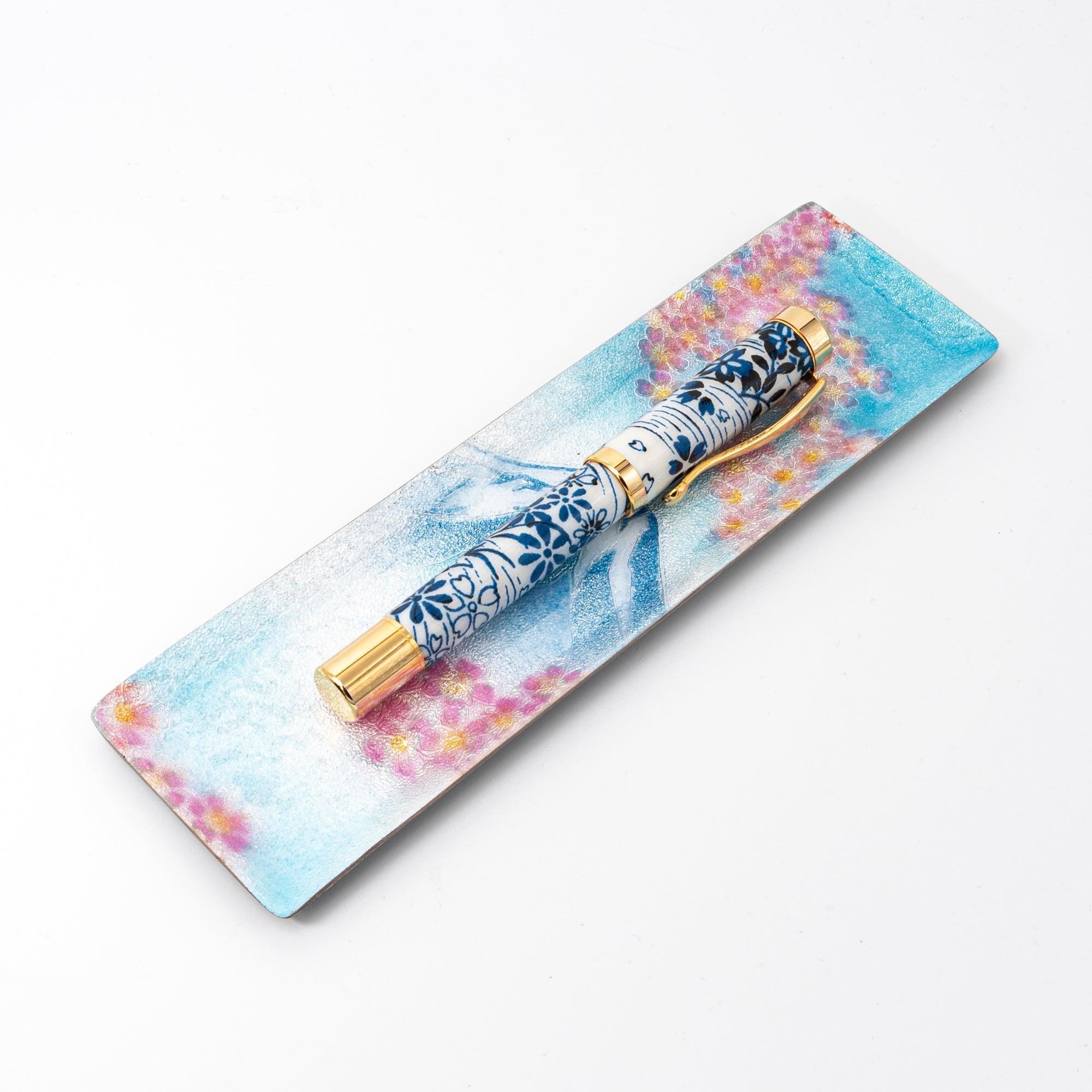 Sakura and Fuji shippo ware slim pen tray, angled view on white background with blue floral fountain pen resting inside